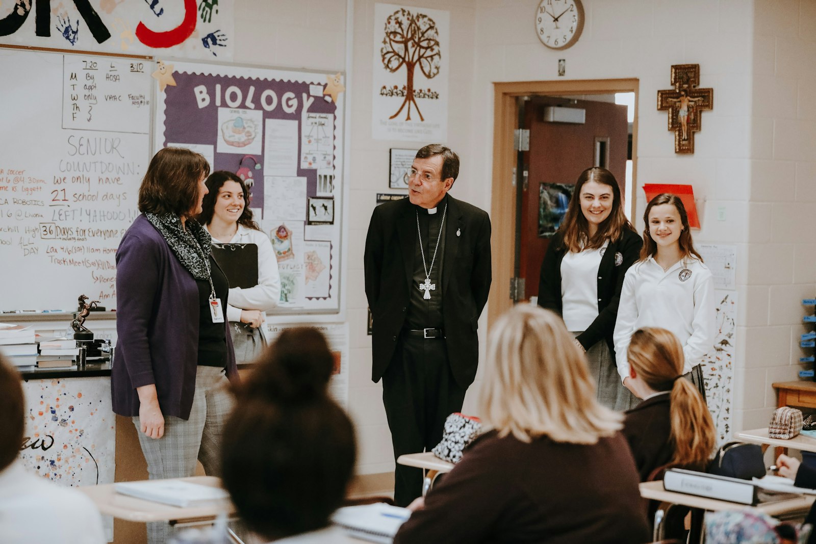 Archbishop Allen H. Vigneron visits with students at teachers at St. Catherine of Siena High School in Wixom. Deacon Costello said the Office of Catholic Schools is working to implement the archbishop's vision for Catholic education in the Archdiocese of Detroit.