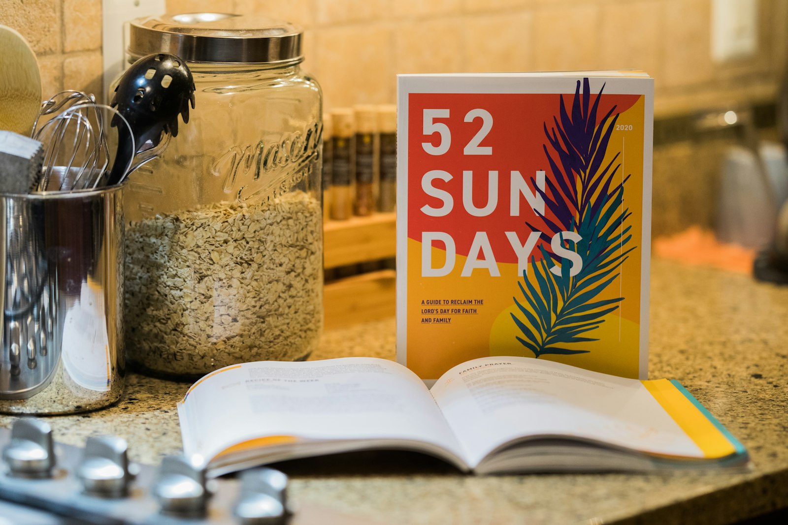 A promotional image shows a copy of "52 Sundays," a handbook created by the Archdiocese of Detroit's Department of Evangelization and Missionary Discipleship that helps families live the Lord's Day in prayer, family gatherings and activities. (Melissa Moon | Detroit Catholic)