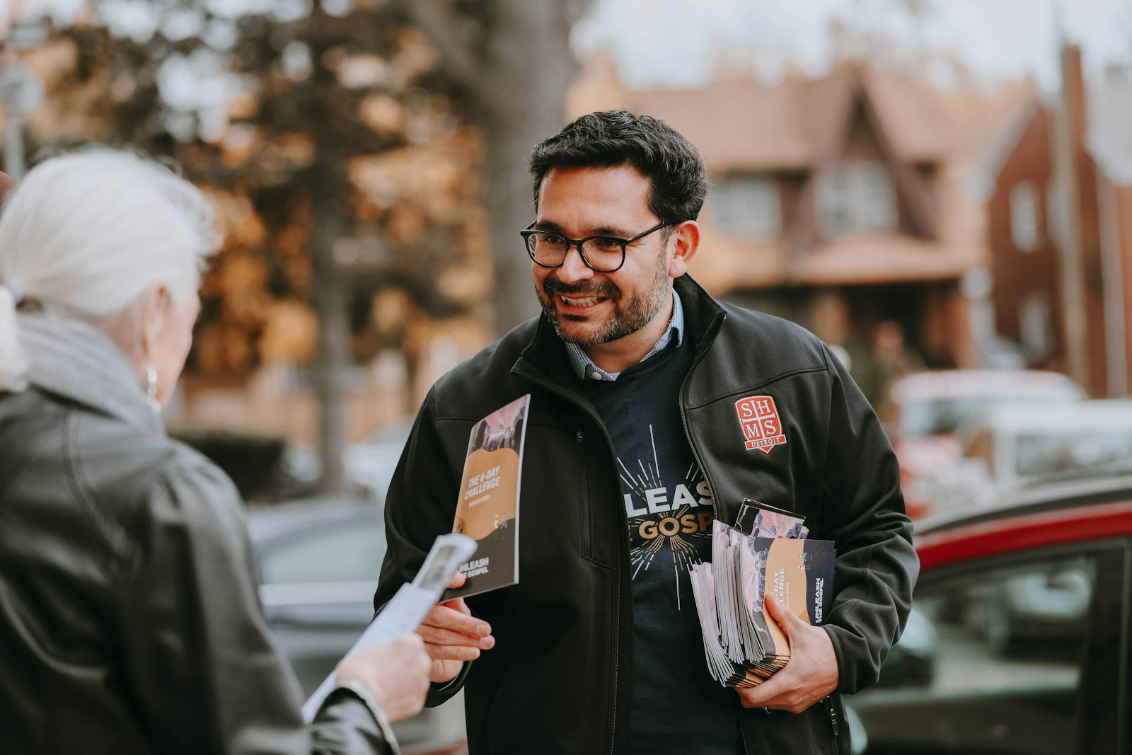 Edmundo Reyes, director of communications for the Archdiocese of Detroit, hands out materials during "Unleash the Gospel Weekend" in November 2018, a two-day blitz that resulted in more than 47,000 local Catholics signing up to take part in the Unleash the Gospel movement. (Naomi Vrazo | Detroit Catholic)