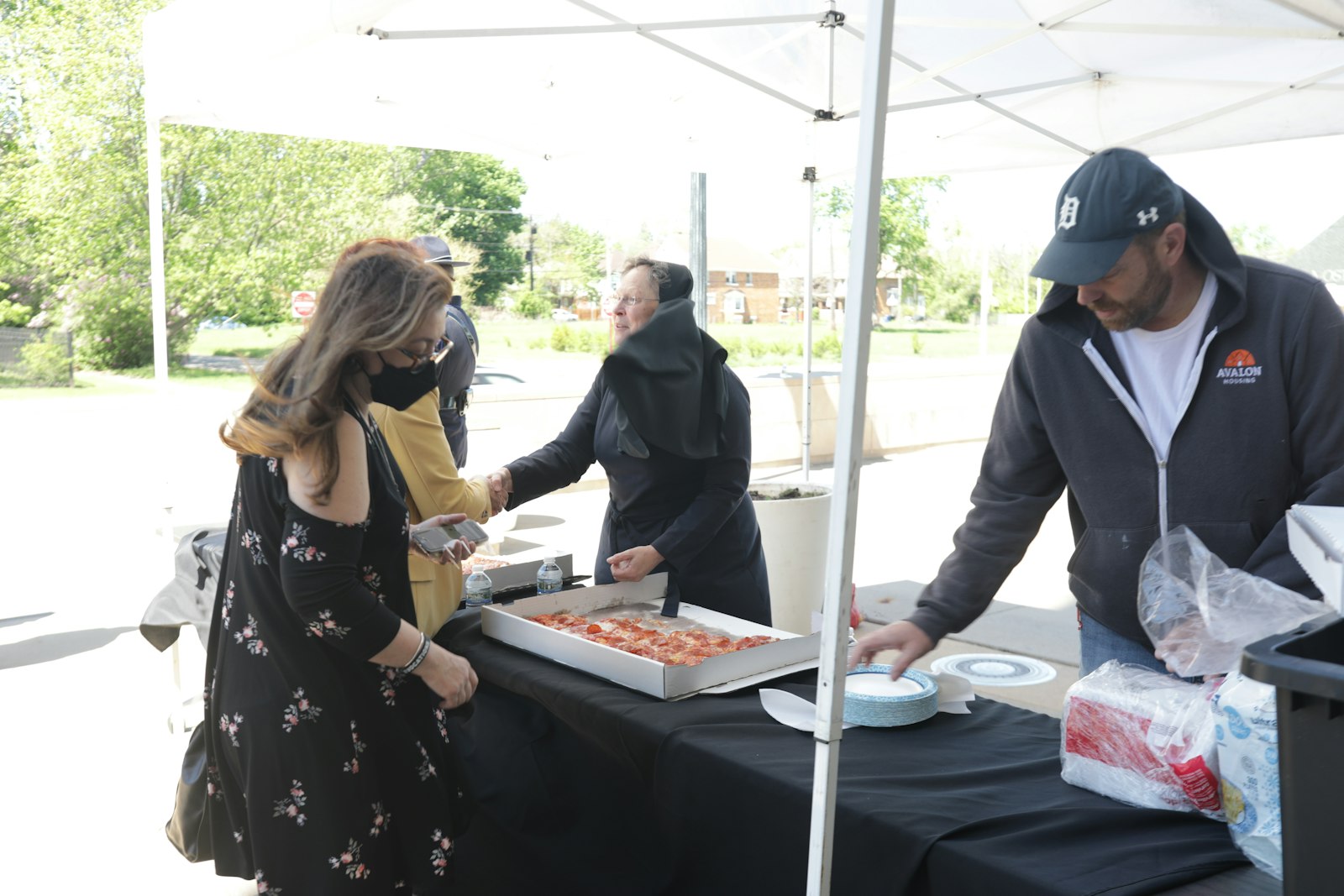 Sr. Esther Mary Nickel, RSM, and Anna Romano set up pizza for police officers after the Mass for First Responders at the Cathedral of the Most Blessed Sacrament on May 17.
