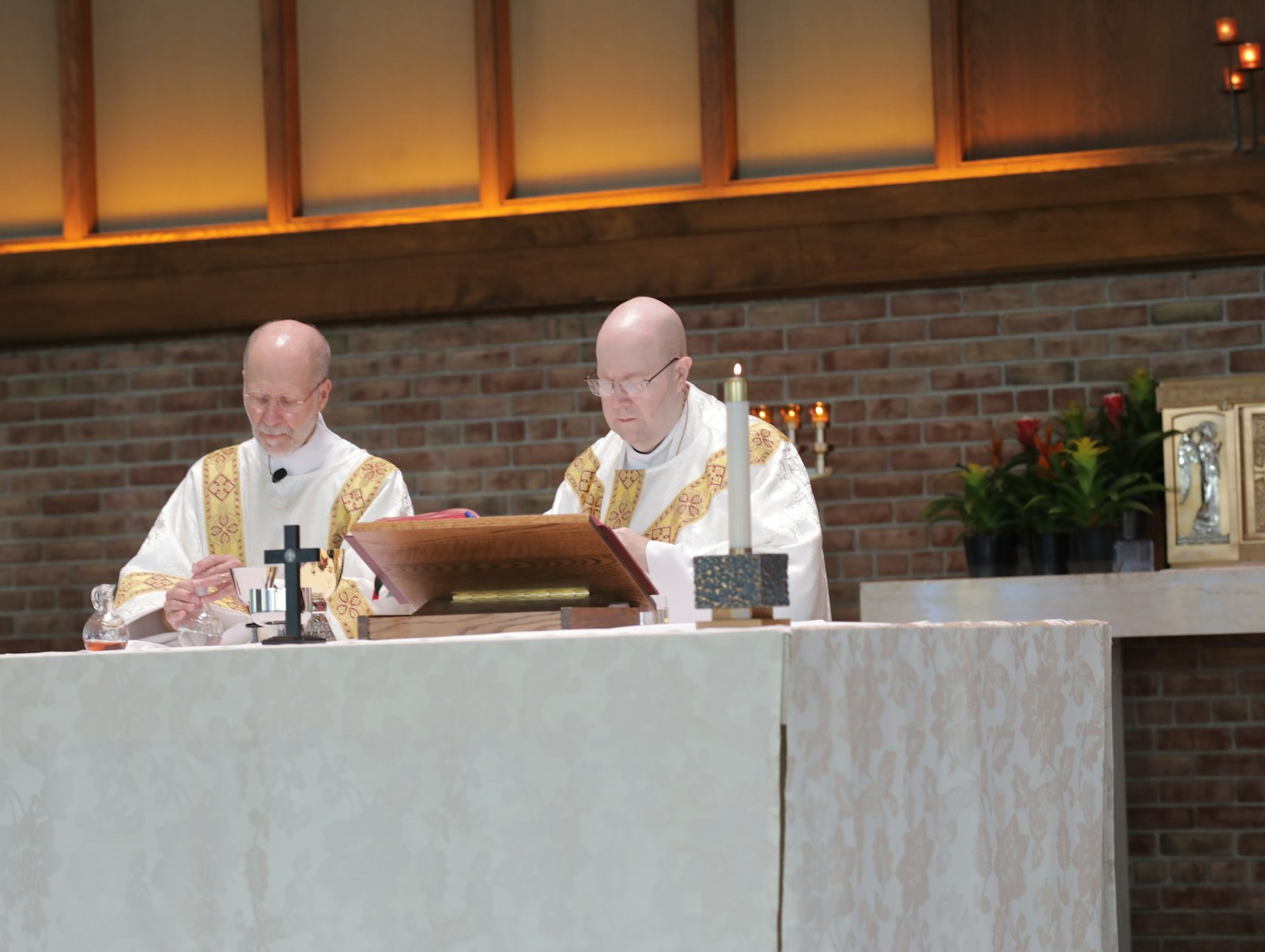 Deacon Daniel Darga, left, assists Fr. Patrick Connell, an "in solidum" priest for the "Sent on Mission" Family of Parishes at Our Lady of La Salette Parish in Berkley. Deacon Darga said the new parish structure will allow parishes to maintain their own worship styles.