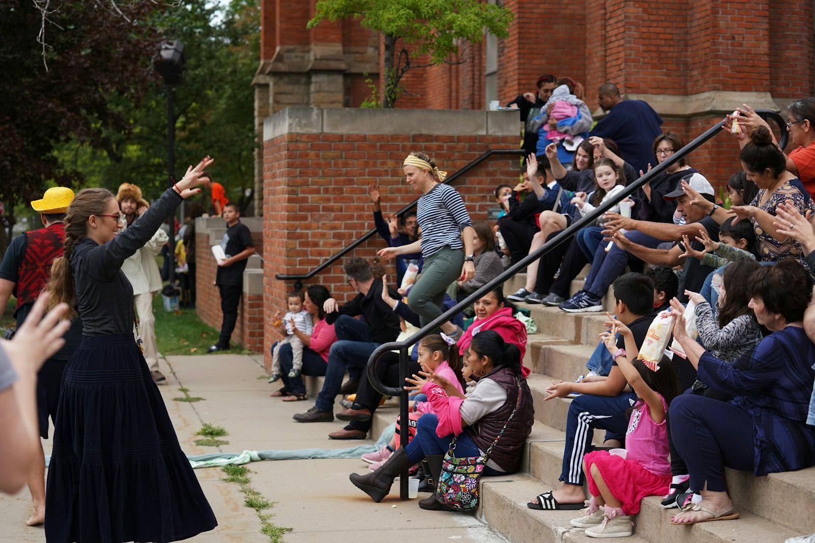 Ste. Anne Parish staff guides a tour group including young children on the steps leading up to the church. While founded by French missionaries, today, Ste. Anne is host to a vibrant and diverse congregation serving Detroit's Mexicantown and Delray neighborhoods — service that will only be enhanced by the church's innovative partnership with The Catholic Initiative, Archbishop Vigneron said. (Photo by Paul Duda | Detroit Catholic)