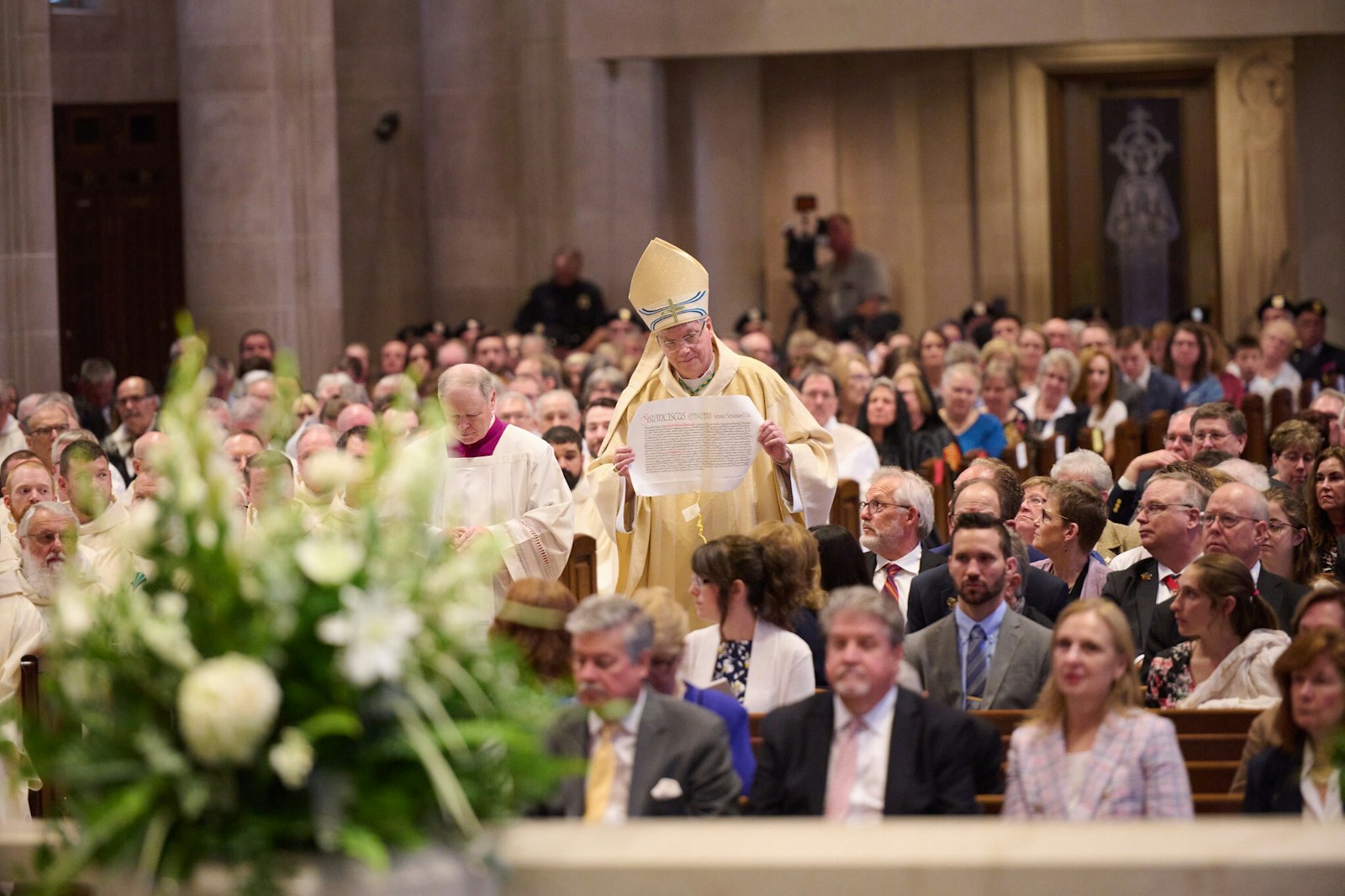 Bishop Battersby processes through the Cathedral of St. Joseph the Workman holding the apostolic mandate from Pope Francis announcing his appointment as the 11th bishop of La Crosse.