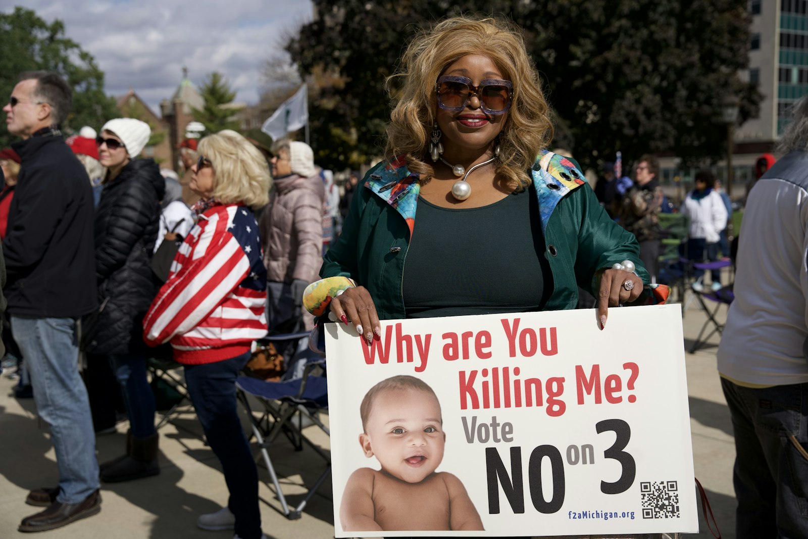 Linda Lee Tarver, who is running for a seat on the Michigan Board of Education, holds up a sign at the Lansing prayer rally.