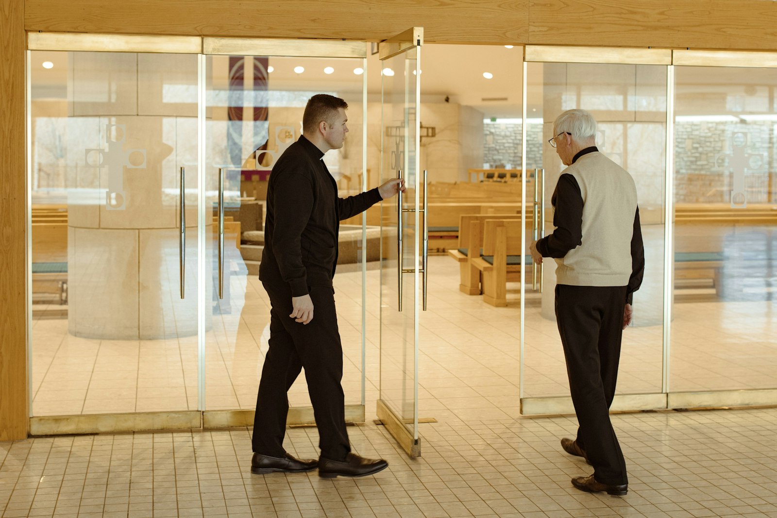 Fr. Nowak opens the door to the church for Msgr. McEnhill on March 1 at St. Hugo of the Hills Parish in Bloomfield Hills.