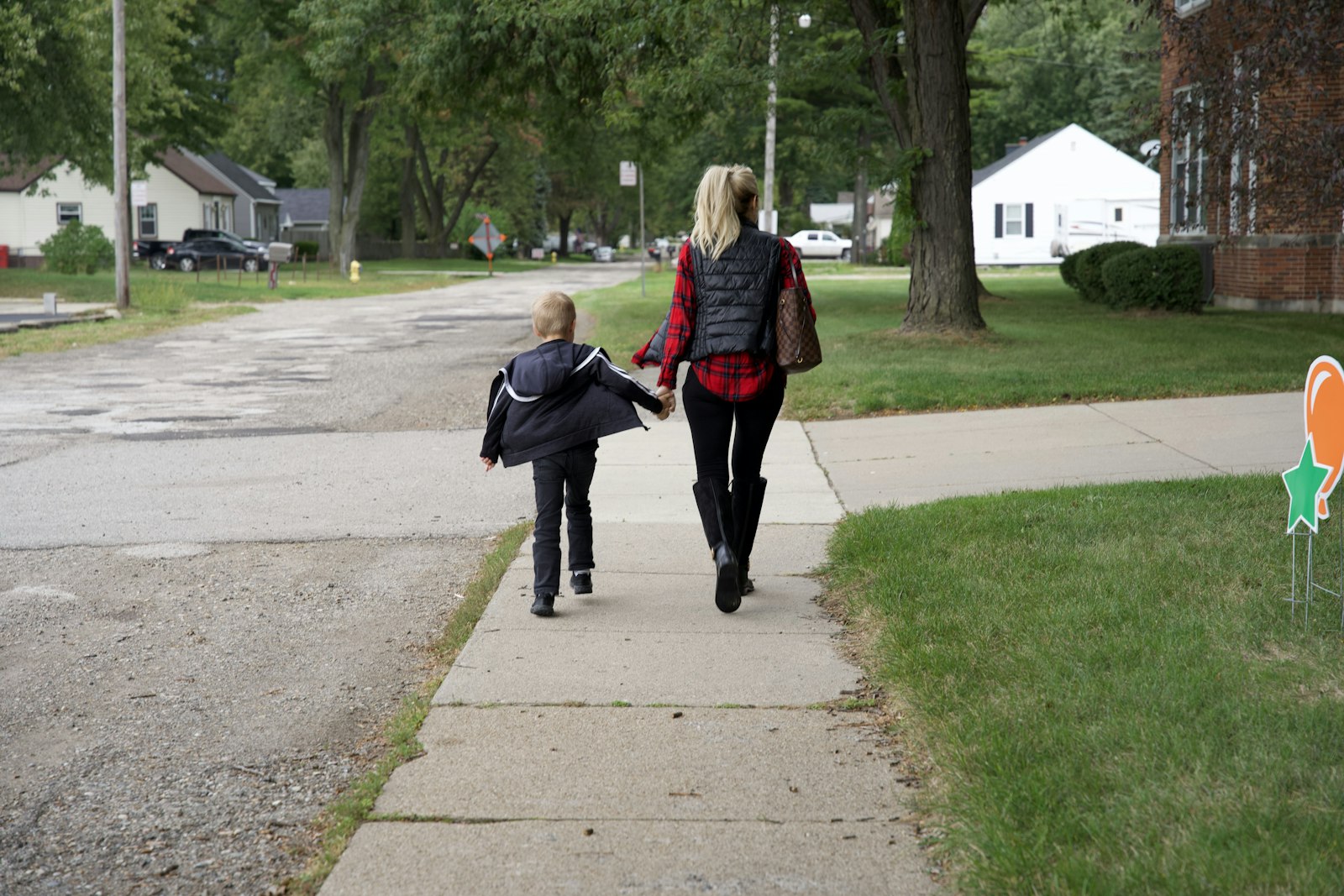 A mother walks her son into the former St. Louis School building in Clinton Township on the grounds of St. Louis Parish. The former school, which was being used as a part-time parish hall, has found new life housing a revitalized religious education program for the Family of Parishes.