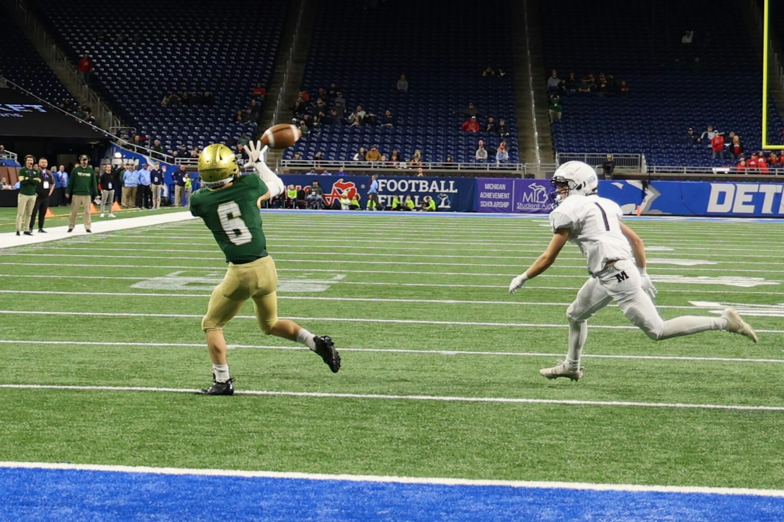 Late in the fourth quarter, Jackson Lumen Christi split end Gabe King catches a pass for the eventual winning touchdown in the Titans’ 34-30 victory over Menominee. (Photo by Rick Bradley | Special to Detroit Catholic)