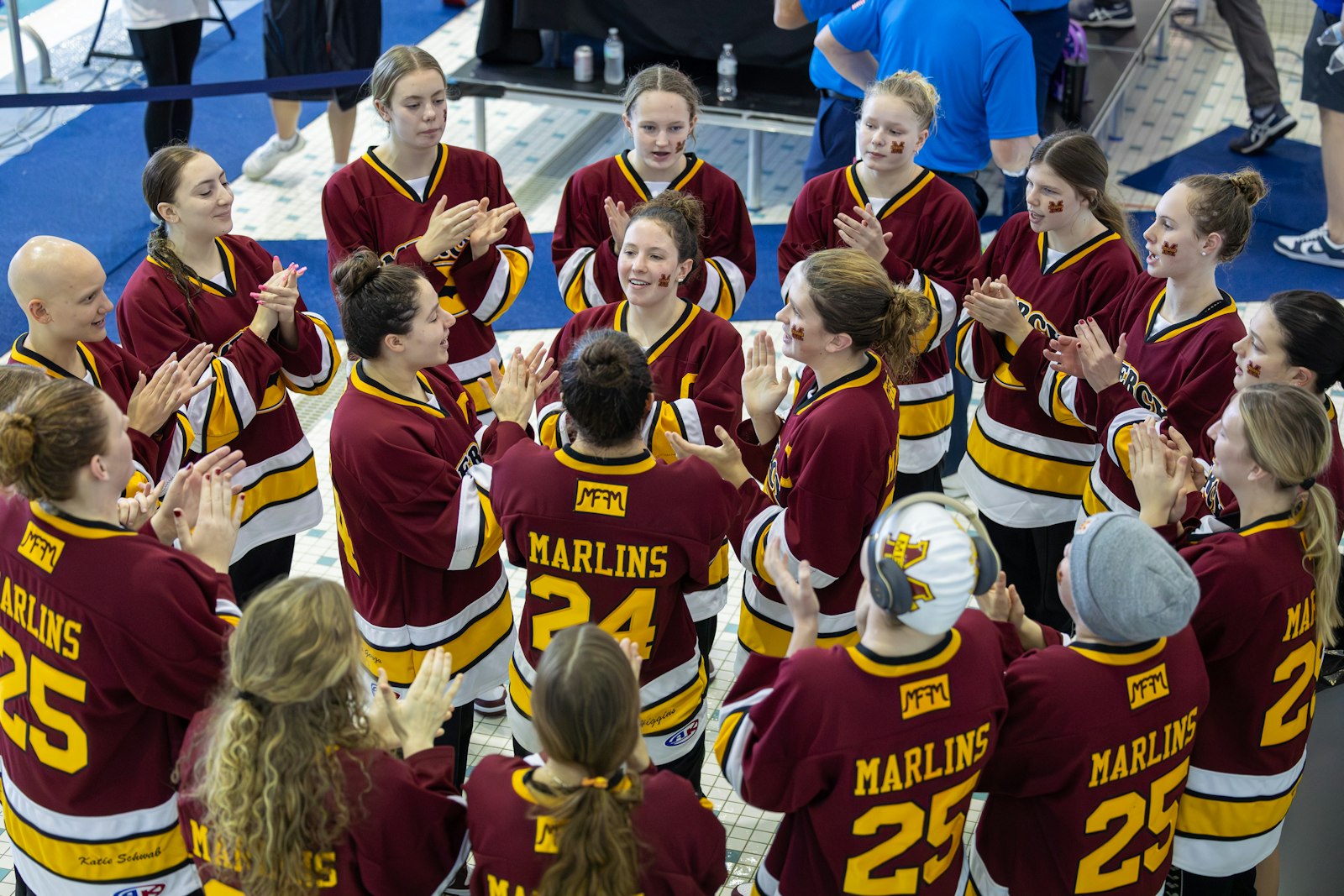 Swimmers from Farmington Hills Mercy get pumped up to compete in the Division 2 swimming and diving state finals at the Holland Aquatic Center. The Marlins led the field with 326 points, collecting their 12th team title in program history.