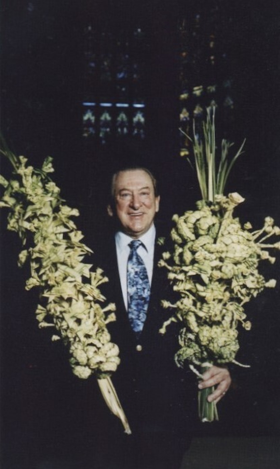 Frederick “Fritz” Wenson holds two of the palm fronds he weaved for Detroit's archbishops. Cardinal Mooney used to save Wenson's designs from year to year. (Photo from Michigan Heritage Awards, 1999)