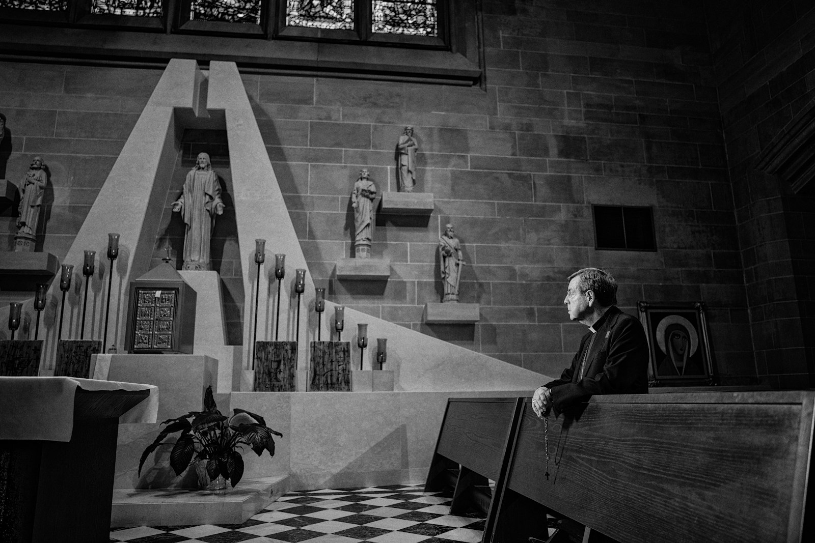 Archbishop Allen H. Vigneron kneels in adoration during an interview for the Archdiocese of Detroit's "I AM HERE" Eucharistic campaign. The campaign, which seeks to encourage Eucharistic adoration and devotion by sharing individuals' stories of encountering Christ in the Eucharist, won several awards at this year's Catholic Media Conference, including the Fr. John Catoir Social Media Evangelization Award. (Valaurian Waller | Archdiocese of Detroit, Detroit Catholic)