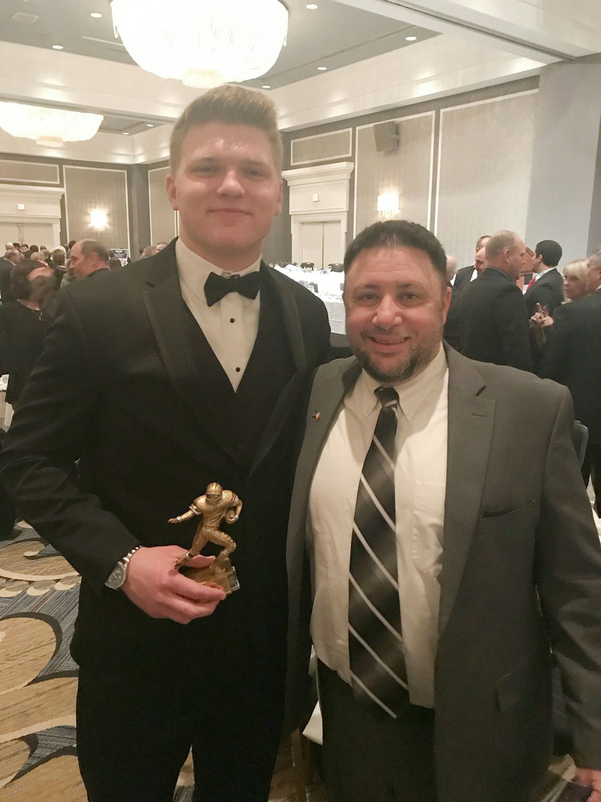 Detroit Lions star Aidan Hutchinson is pictured with Divine Child football coach Chris Laney at the Detroit Free Press Dream Team Banquet in 2017. Laney was the offensive coordinator during Hutchinson's time at Divine Child from 2015-18, where he played tight end for the Falcons. (Courtesy of Chris Laney)