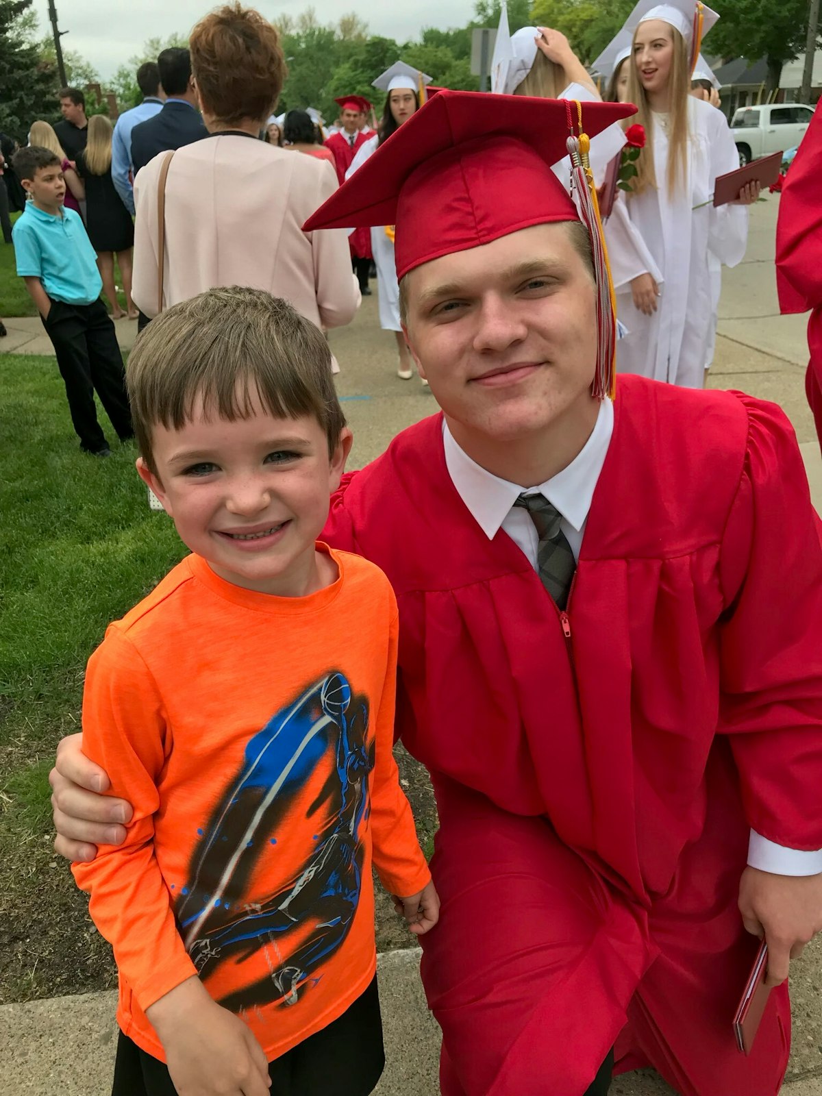 Aidan Hutchinson at his Divine Child graduation with Niall Laney, Chris Laney's son. Chris said Aidan maintains close contact with the Divine Child community, and frequently asks Laney for updates on the Falcons. (Courtesy of Chris Laney)