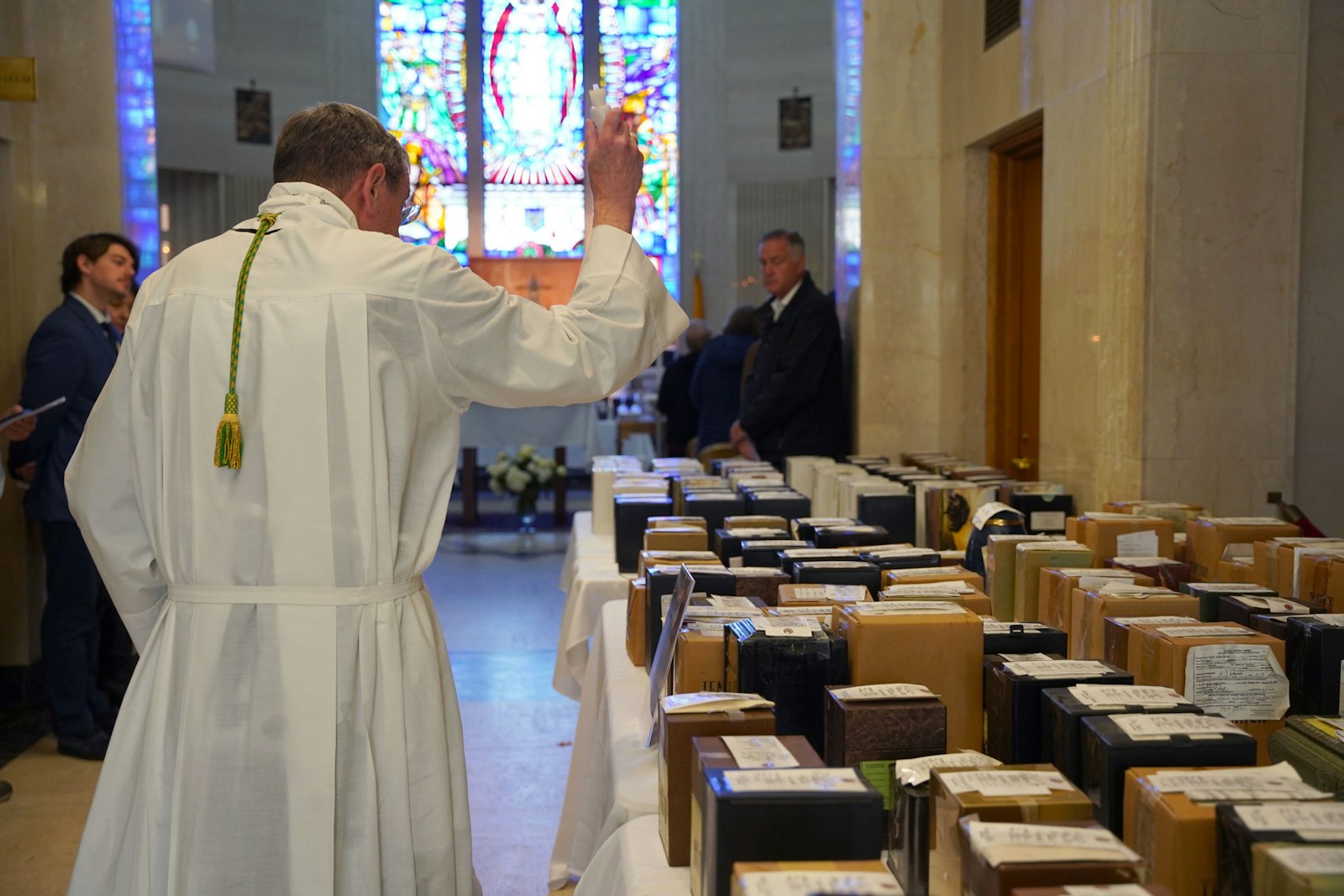 Archbishop Vigneron blesses the cremains brought to Holy Sepulchre Cemetery in Southfield for the Gather Them Home initiative. The cremains will be placed in the All Souls Remembrance crypt free of charge.