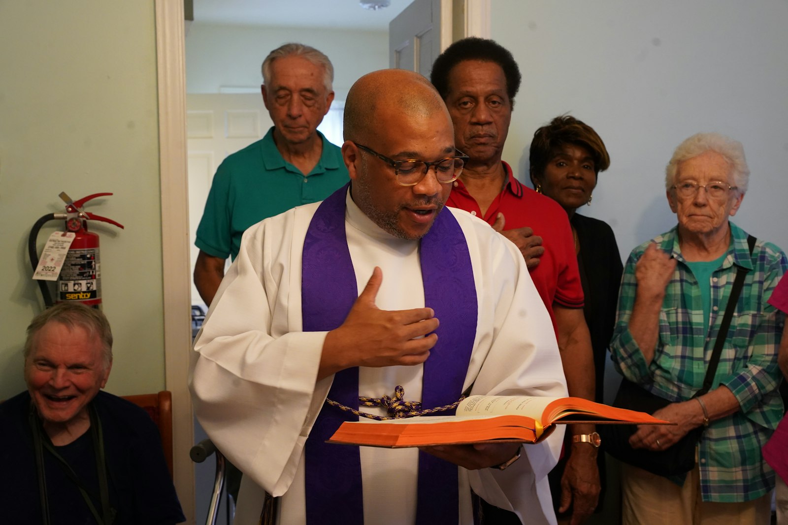 Fr. John McKenzie of Christ the King Parish blesses the Bakhita House on Sept. 7. Fr. McKenzie said it's appropriate to name a house that will shelter migrants after St. Josephine Bakhita, a woman from Sudan who was taken into slavery to Italy, where she eventually was granted her freedom and found faith in Christ.