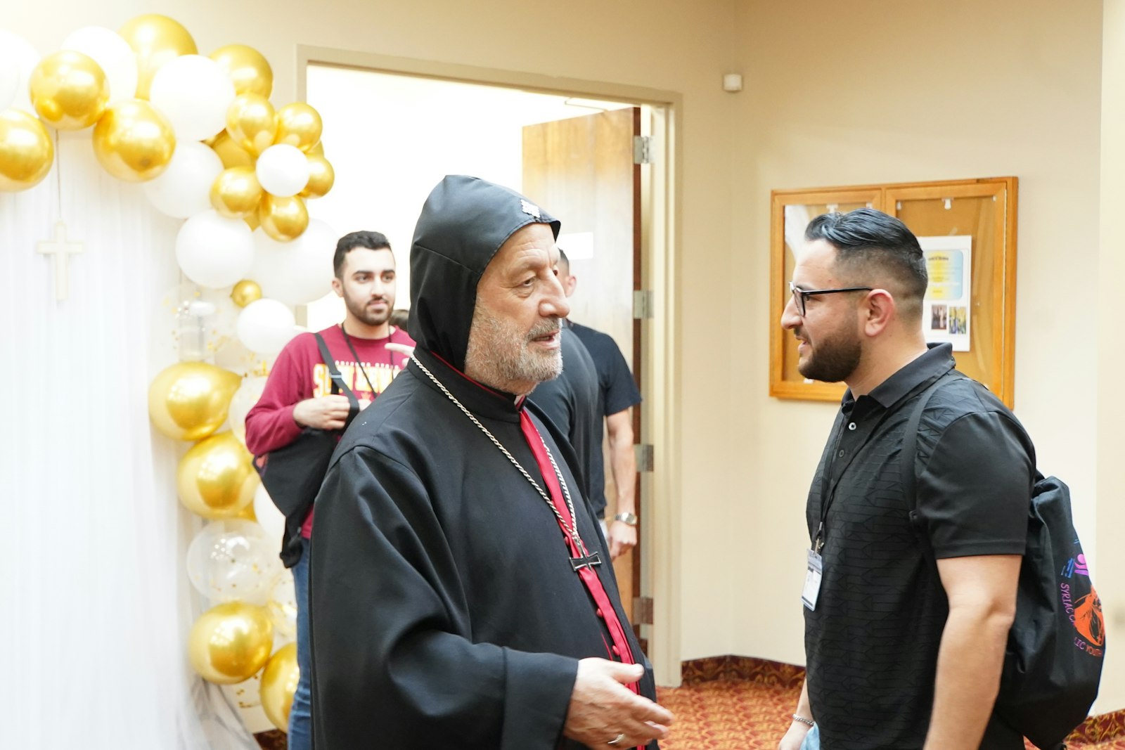 Bishop Barnaba Yousif Habash, bishop of the Eparchy Our Lady of Deliverance, the U.S.-wide eparchy for all Syriac Catholics, speaks with youth before the start of the 12th Syriac Catholic Youth Convention at St. Toma Syriac Cathedral in Farmington Hills on July 6. The convention is an opportunity for Syriac youth to come together to share in the faith.