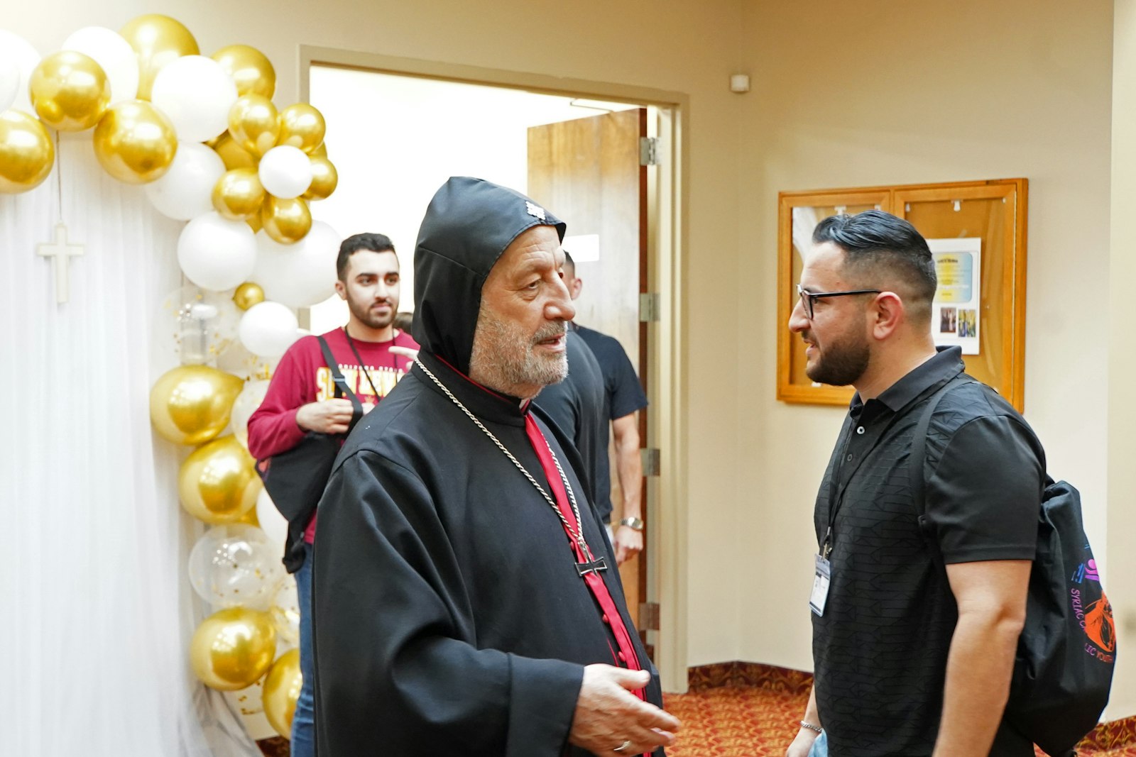 Bishop Barnaba Yousif Habash, bishop of the Eparchy Our Lady of Deliverance, the U.S.-wide eparchy for all Syriac Catholics, speaks with youth before the start of the 12th Syriac Catholic Youth Convention at St. Toma Syriac Cathedral in Farmington Hills on July 6. The convention is an opportunity for Syriac youth to come together to share in the faith.