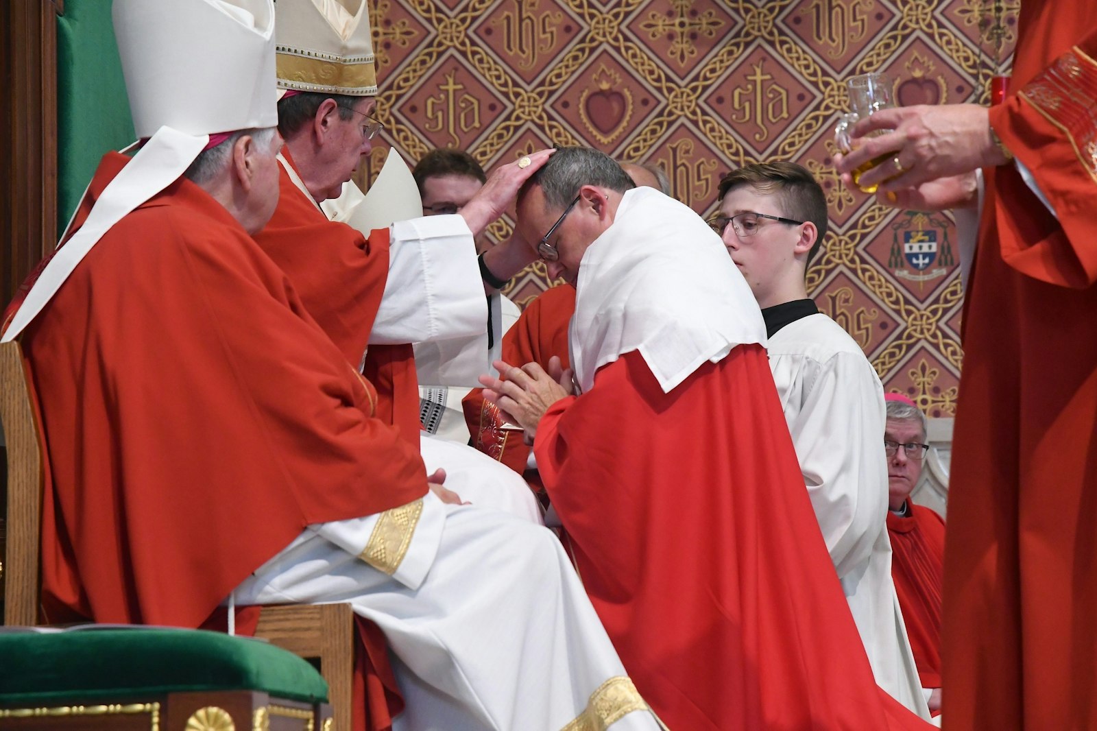 Detroit Archbishop Allen H. Vigneron lays his hands upon the head of Bishop Edward M. Lohse, ordaining him to the episcopate before a standing-room-only congregation July 25 at the Cathedral of St. Augustine in Kalamazoo. (John Grap | Diocese of Kalamazoo)