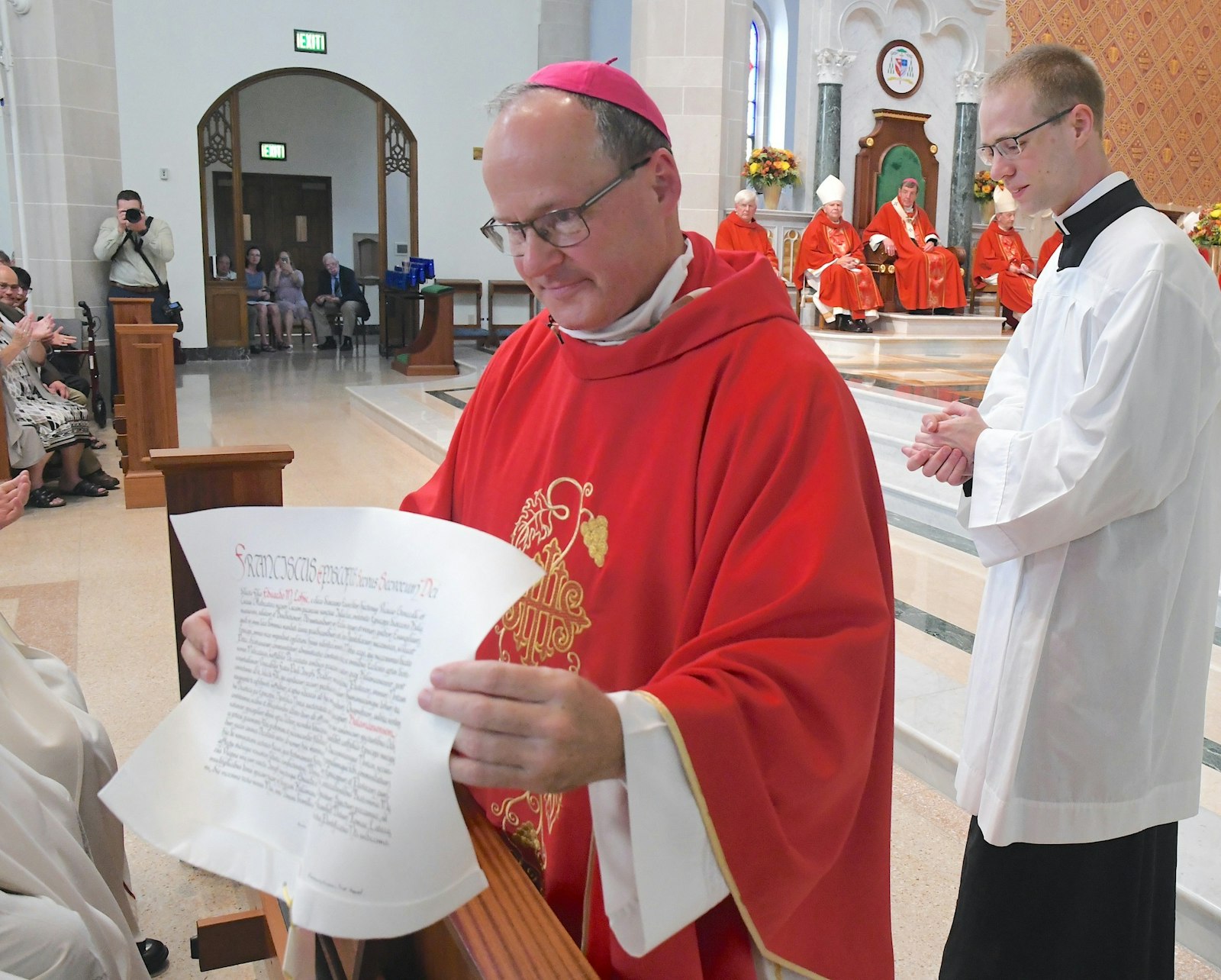 Bishop Lohse shows the faithful the papal decree announcing his appointment as Kalamazoo's bishop. (John Grap | Diocese of Kalamazoo)