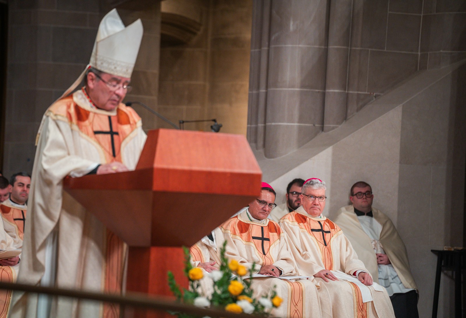 Bishop Monforton, right, listens as Cardinal Christophe Pierre, apostolic nuncio to the United States, reads the proclamation from Pope Francis assigning him to a new ministry in the Archdiocese of Detroit.