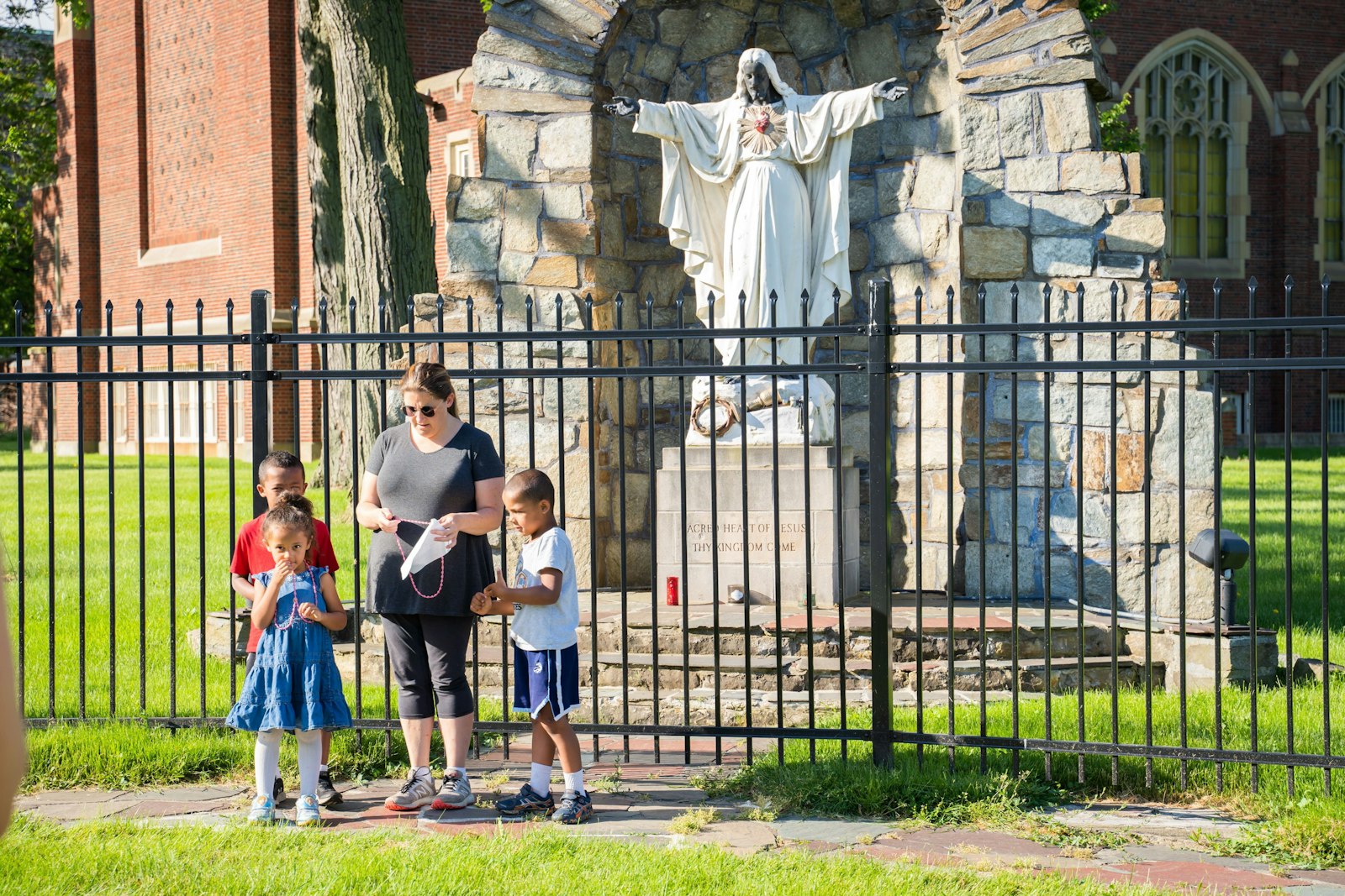 Families pray near a statue of the Sacred Heart of Jesus on the grounds of Sacred Heart Major Seminary in Detroit in 2020. This year marks the 350th anniversary of Jesus' appearance to St. Margaret Mary Alacoque, to whom Christ revealed his Sacred Heart and asked that the devotion be spread. (Valaurian Waller | Detroit Catholic)