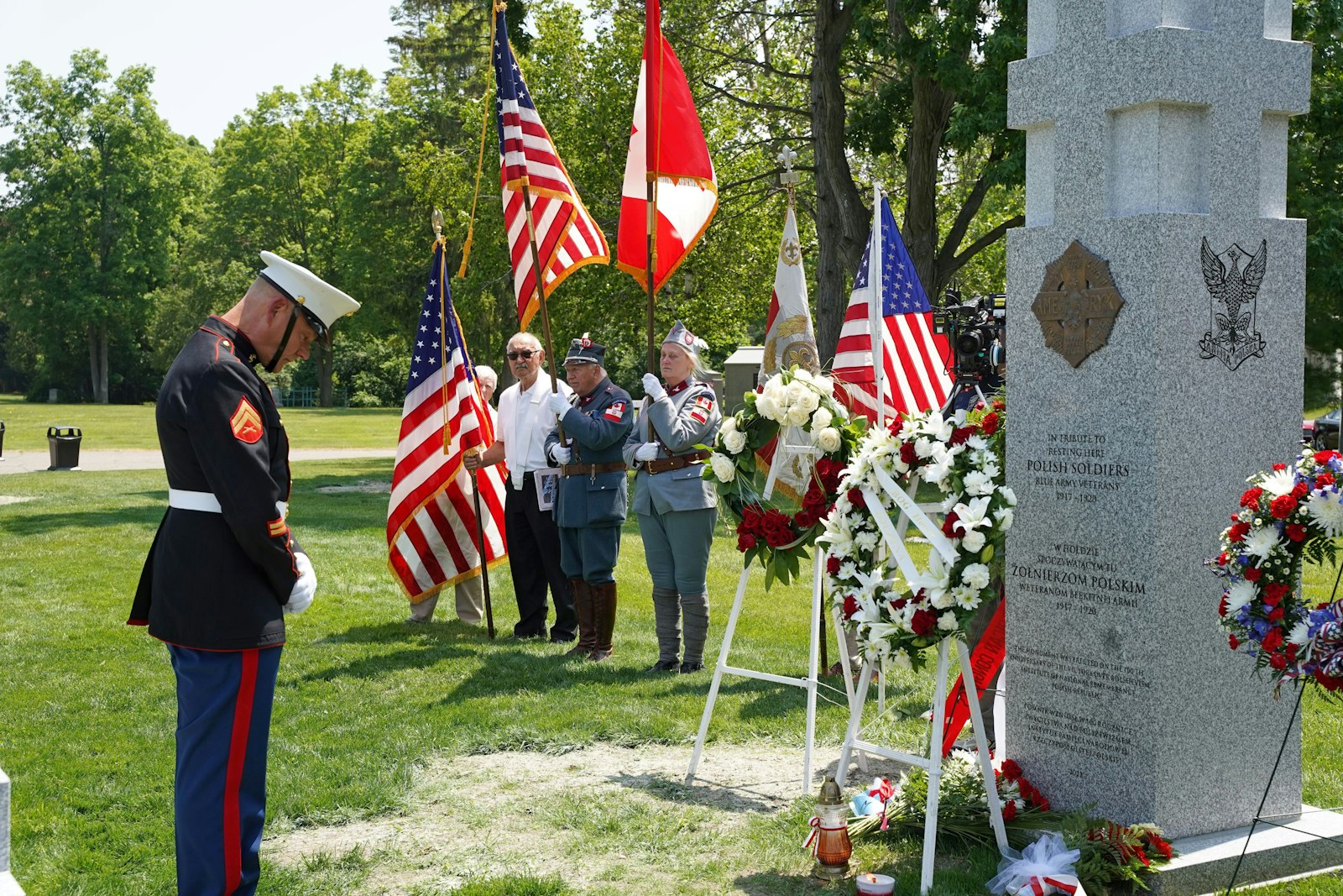 A Marine bows his head in honor before a 6-foot-tall monument in Section 5 of the Holy Sepulchre Cemetery in Southfield commemorating Gen. Jozef Haller's "Blue Army," made up of Polish immigrants from North America, ethnic Poles who were prisoners of war from World War I's Central Powers and other members of Polish diaspora from around the world who fought for an independent Poland from 1918-20.