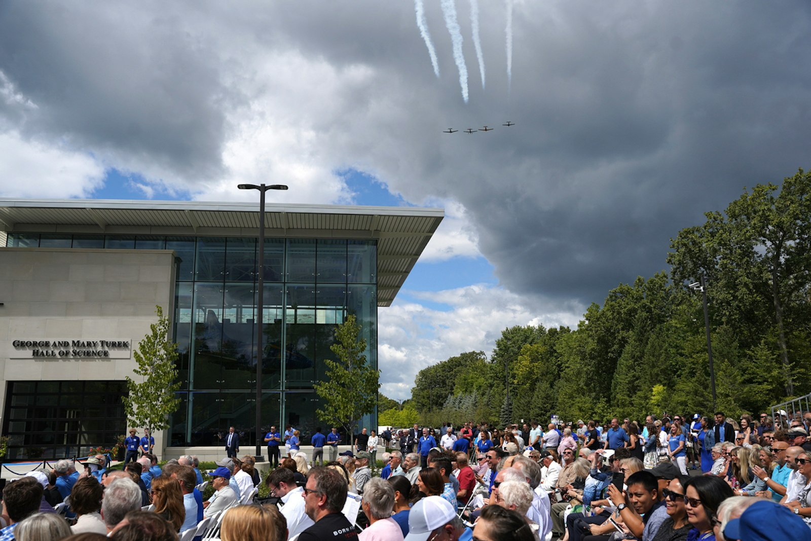 Planes fly overhead during the dedication ceremony for the George and Mary Turek Hall of Science dedication and blessing at Detroit Catholic Central High School in Novi on Aug. 11.