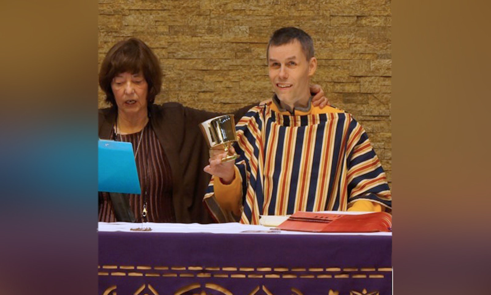 Gregory Petzer acts out the Last Supper by repeating Jesus’ prayer during a re-enactment of the Palm Sunday Gospel readings during Christ Our Light's special needs catechism program April 9.