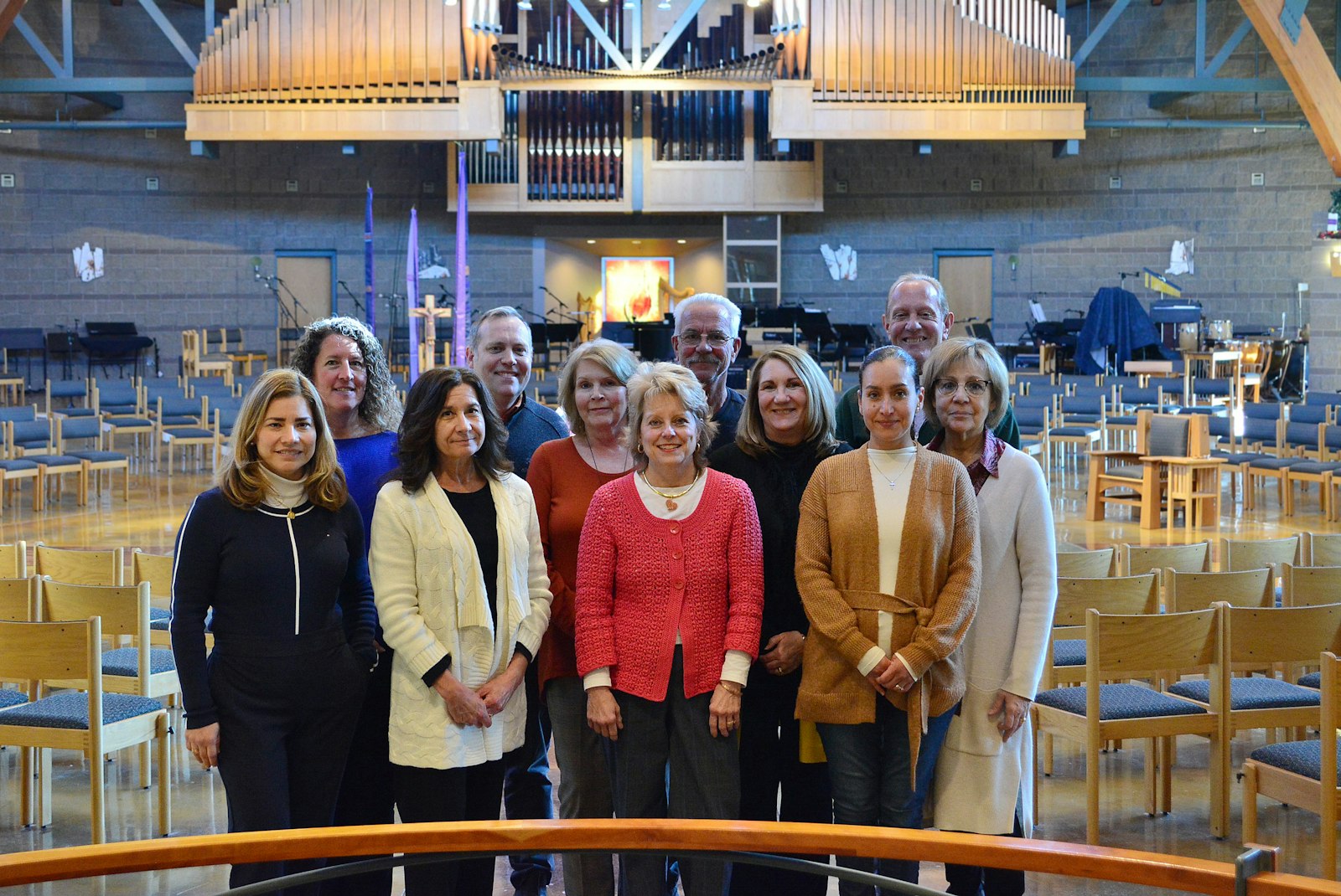 Christ the Redeemer Parish staff members gather in the sanctuary of the church Nov. 26. Even a week after the explosion, the parish continues to collect prayers and donations and reach out to affected residents.