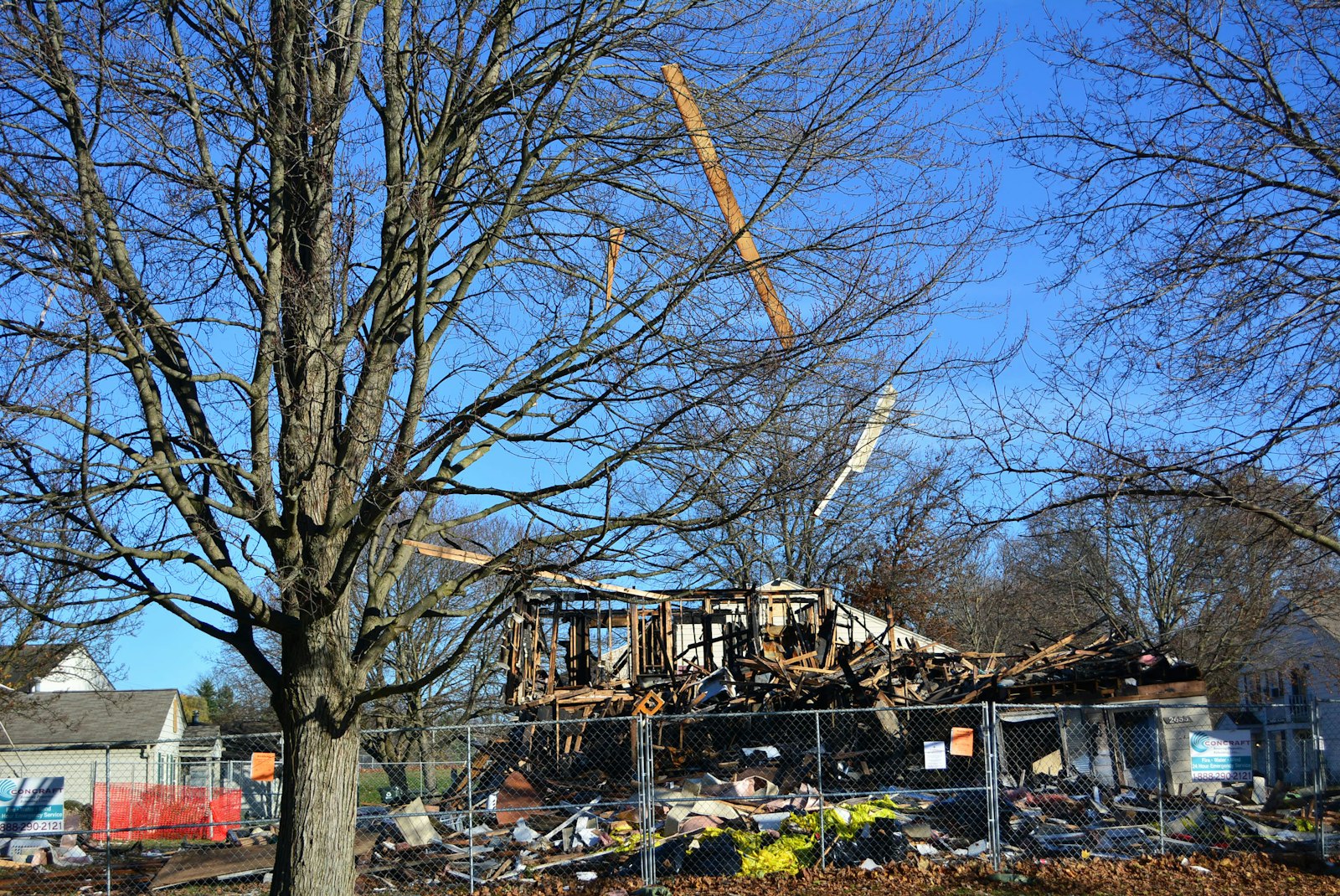 Pieces of wood hang from a tree near a condominium that exploded in Orion Township on Nov. 19. Many of the residents of the Keatington New Town Association condominium complex have been evacuated from their homes as authorities continue to assess the safety of the remaining units.