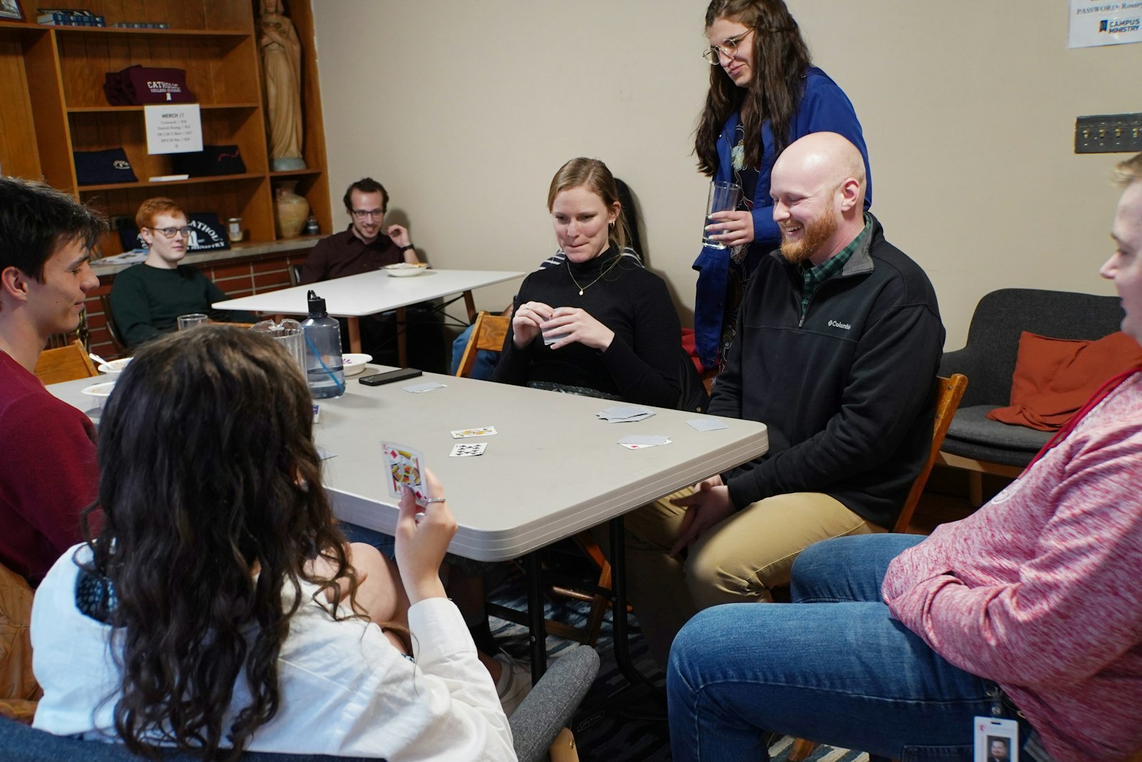 Students play euchre at the Our Lady of the Rosary Student Center following Palm Sunday Mass on April 2. Detroit Catholic Campus Ministry, which serves students at Wayne State University, the University of Michigan-Dearborn and surrounding campuses, strives to build community through friendship and faith for current Catholic students and students interested in learning the Catholic faith.