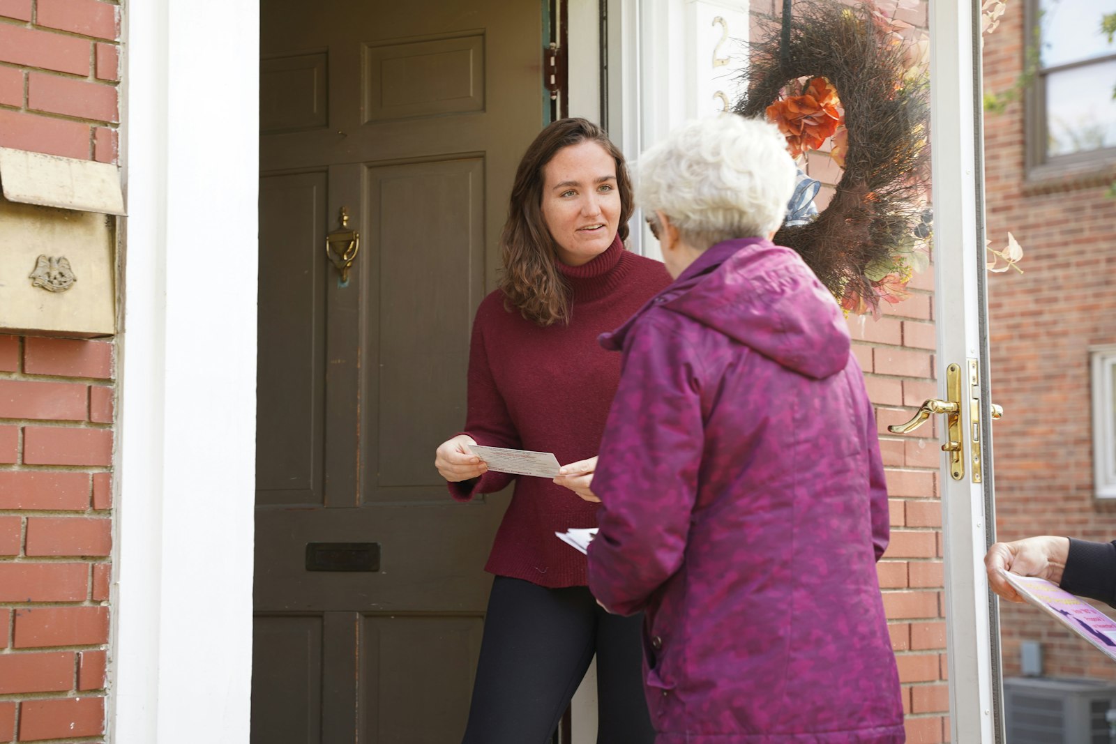 Peggy Stack, right, speaks with a Royal Oak voter Oct. 14 about the dangers of Proposal 3. Canvassers are given a script by organizers and a list of homes to visit in an area. Canvassers aren't expected to debate voters, just let them know that Proposal 3 is on the ballot and how the radical proposal would change Michigan law.