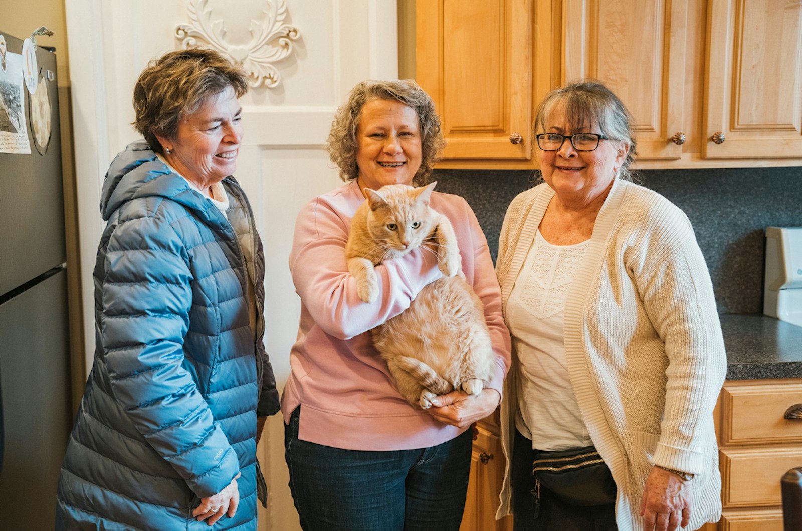 Casey the cat with his "aunts" at Sweetest Heart of Mary Church, Janina Andrus, Kathy Kuhn and Bernie McKernan.