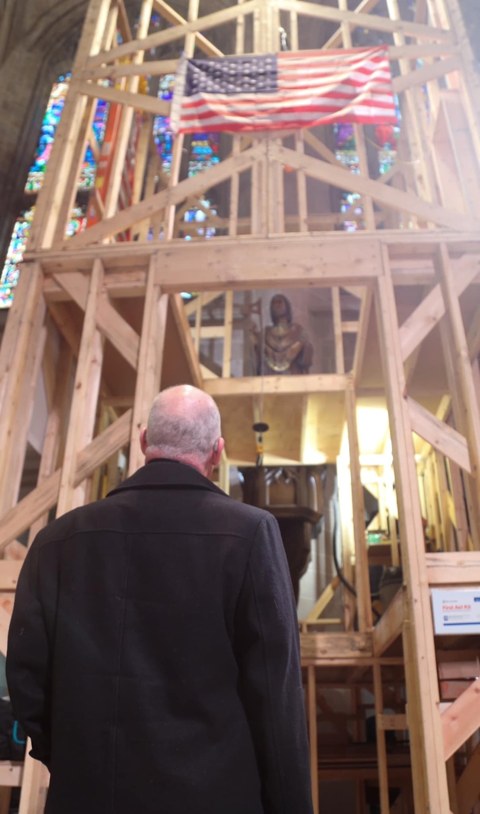 Fr. J.J. Mech looks on as a statue of St. James the Less is installed above its pillar in the Cathedral of the Most Blessed Sacrament in December.