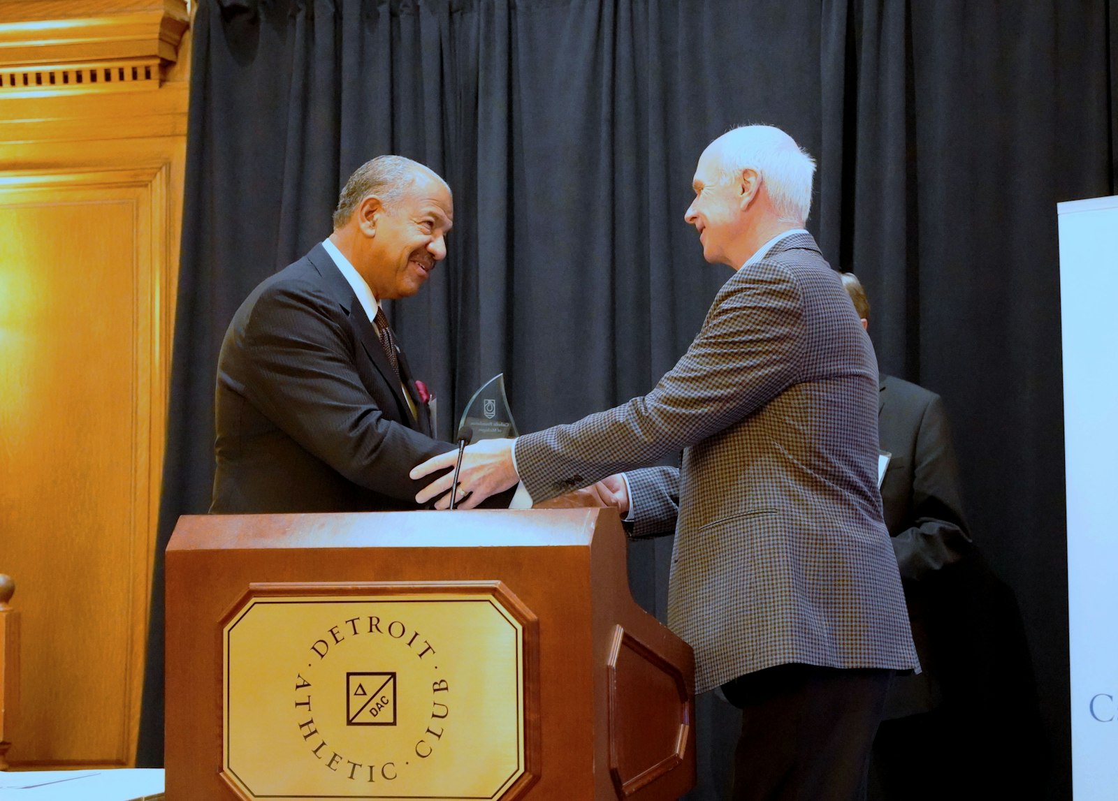 Incoming Catholic Foundation of Michigan chairman Chris Allen, left, thanks Patrick Fehring, the founding chairman, for Fehring's five years of service to the independent, lay-led fundraising organization.