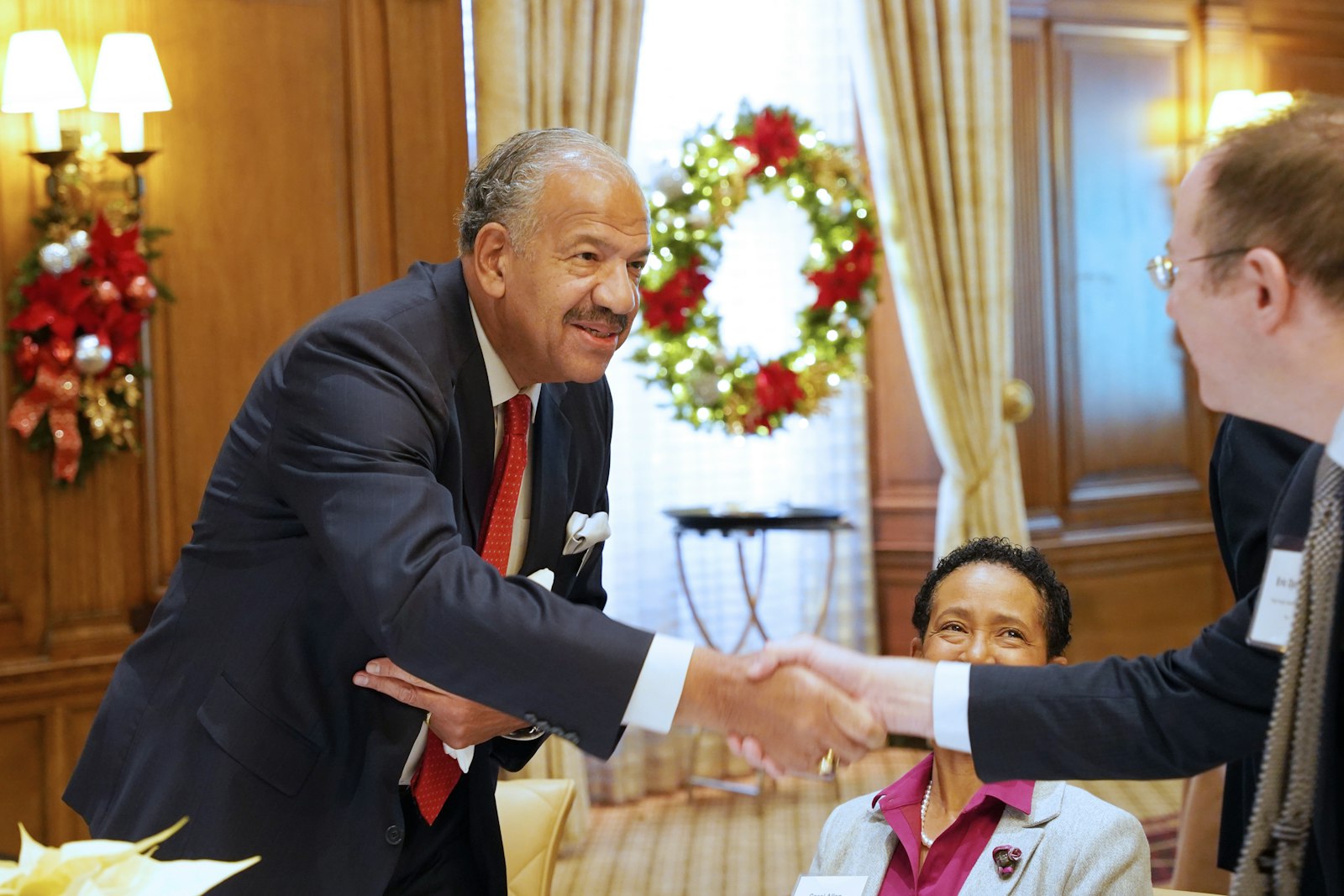 Chris Allen, board chairman for the Catholic Foundation of Michigan, greets a grant recipient. A total of $183,900 in grants were awarded Dec. 13, a 35 percent increase from 2022.