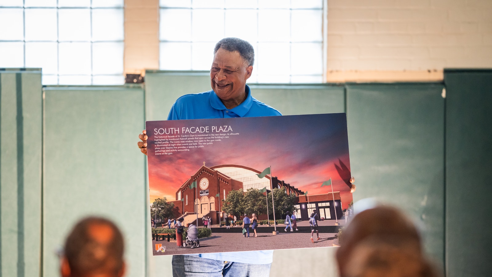 Charlie Edge, a Northeastern High School in Detroit graduate and former coach at St. Martin de Porres High School, holds up a renderings of the proposed renovated front entrance to Ceciliaville.