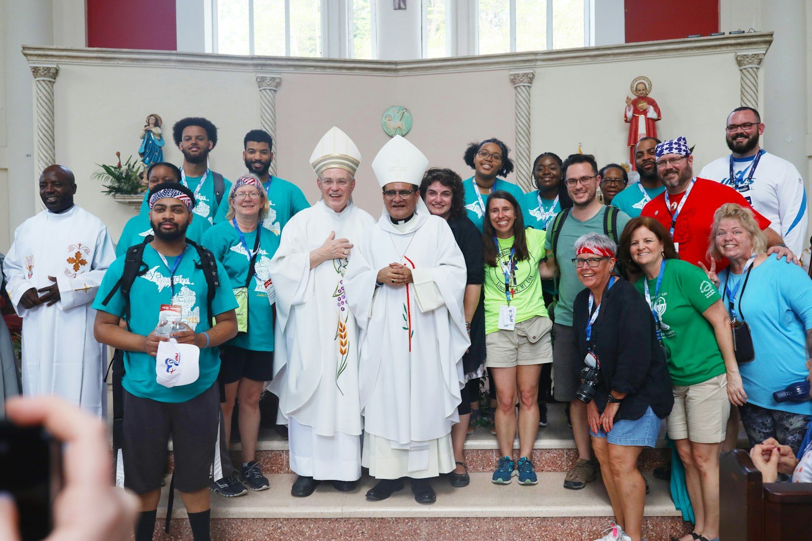 Detroit Auxiliary Bishops Donald F. Hanchon, left, and Arturo Cepeda pose for a picture with Detroit pilgrims during World Youth Day in Panama City, Panama, in 2019.