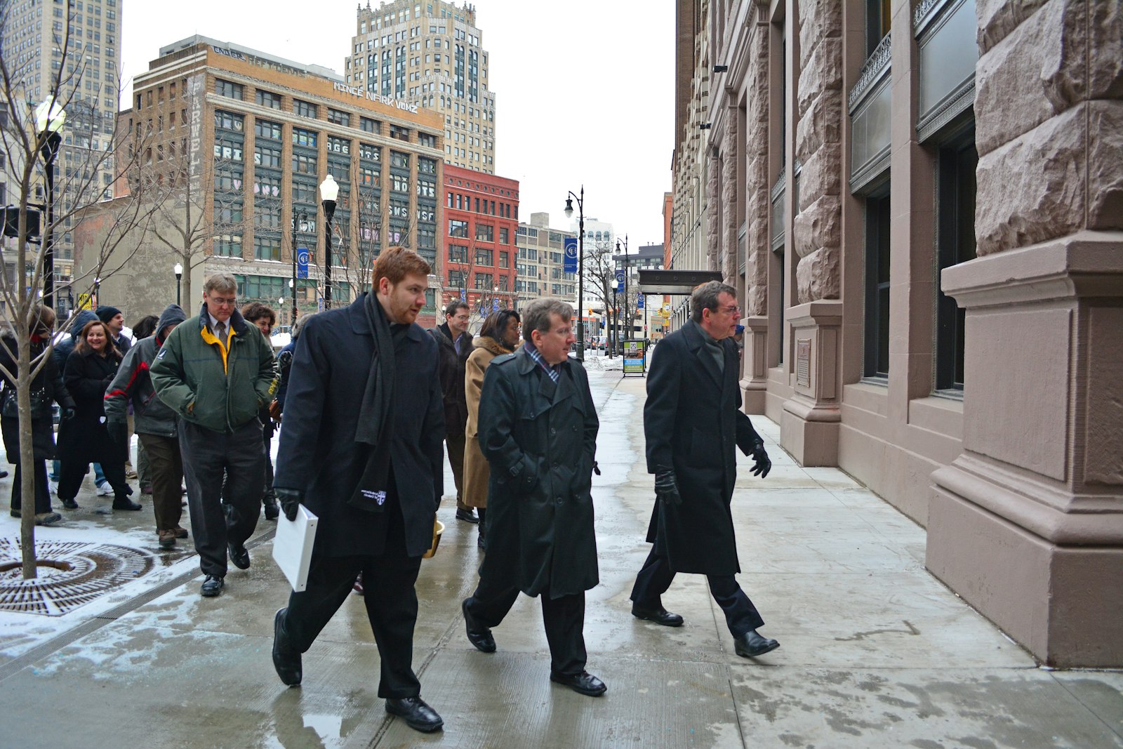 Archbishop Vigneron leads members of the archdiocesan curia from the former Chancery building on Washington Boulevard to their new headquarters in Capitol Park on Feb. 9, 2015. (Michael Stechschulte | The Michigan Catholic)