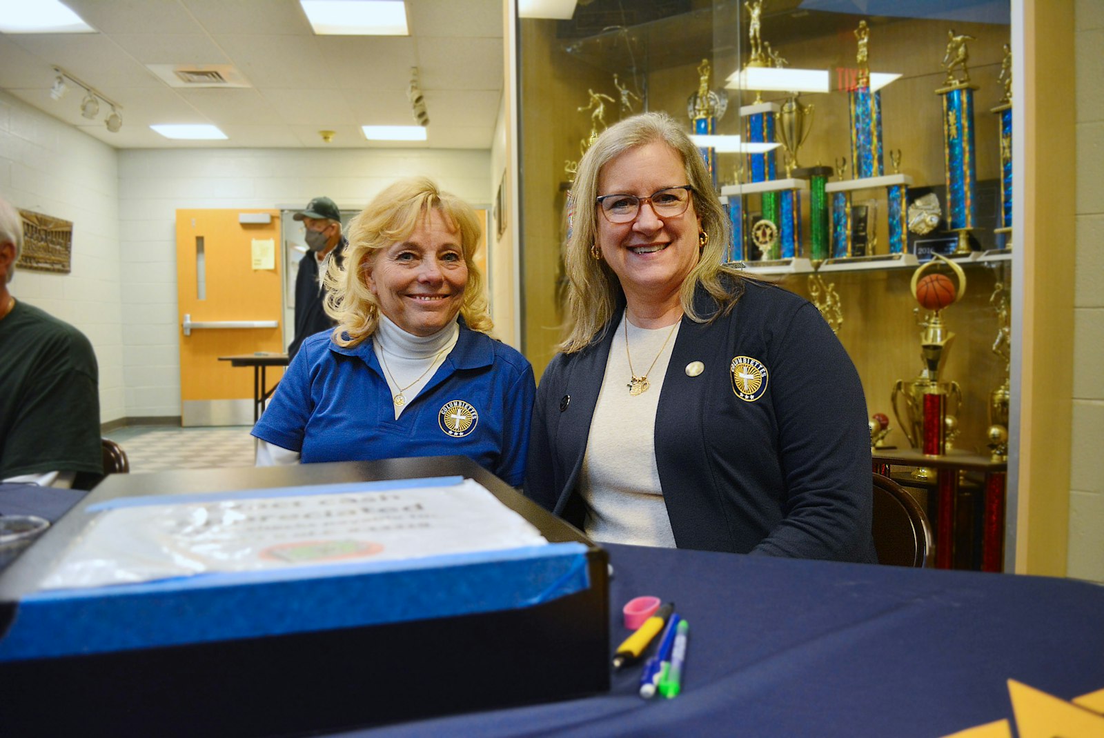 Columbiettes Jill Koterba, left, and Jennifer Fitzgerald work the ticket booth during St. Patrick's fish fry on Feb. 24.