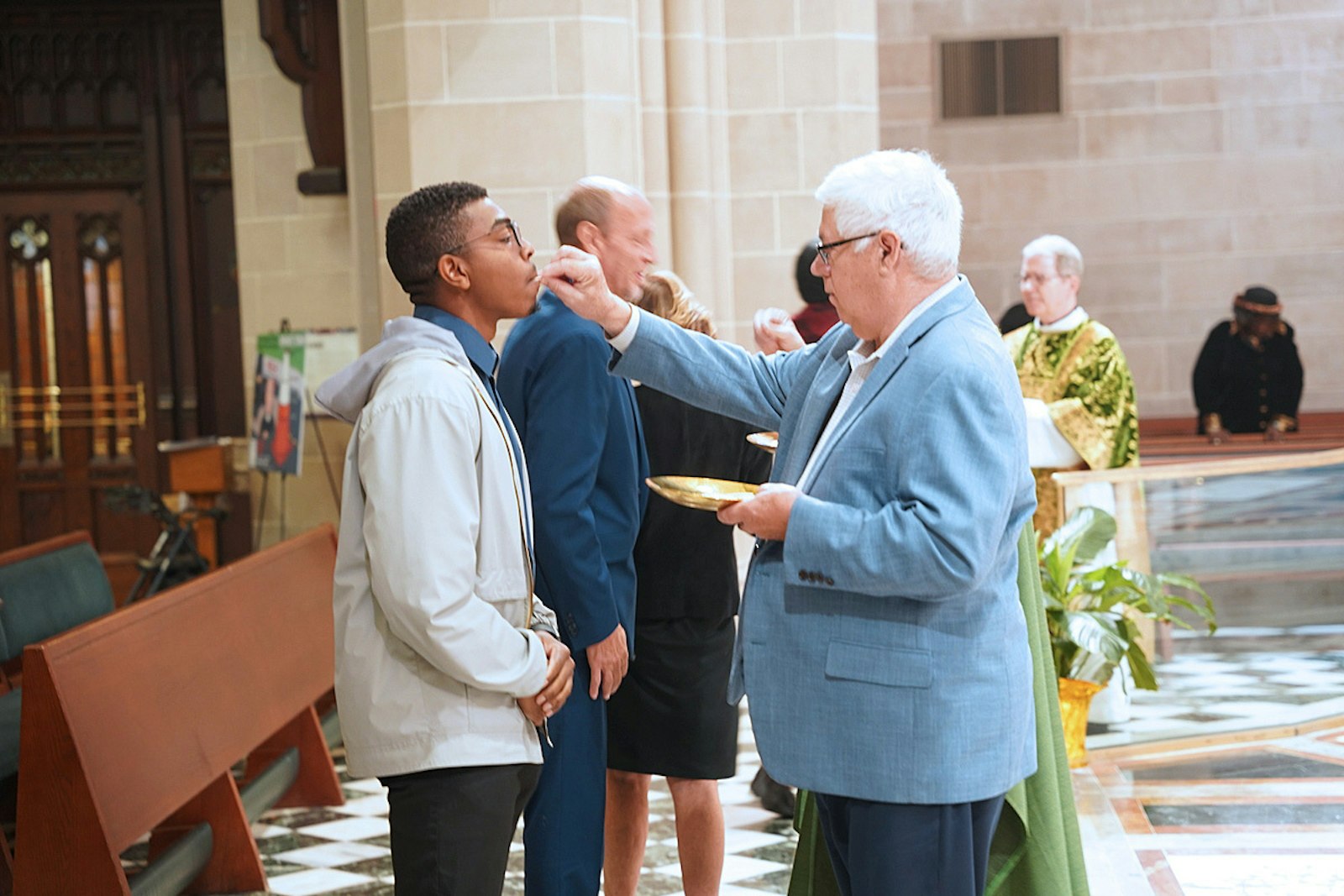 A man receives Communion during the Mass for the Sanctity of Life. The archbishop noted that the Catholic Church's call to protect the dignity of life from conception to natural death stems from Christ's love for all, rooted in the creation of humanity in God's image.