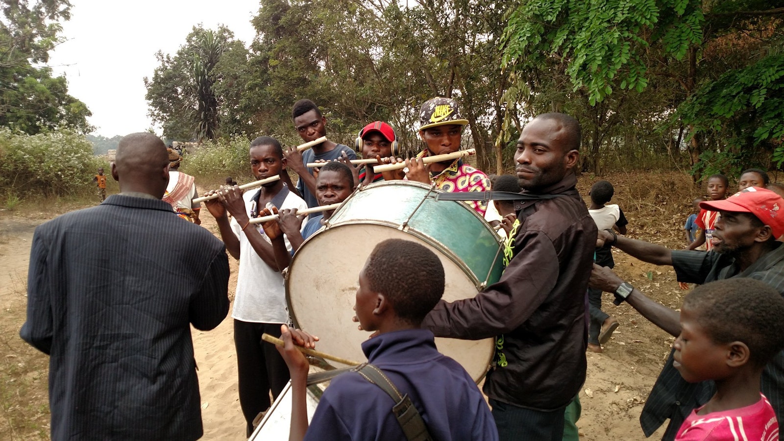 The townspeople of Yassa await the arrival of members of Friends of the Congo to their village with drums and music for the dedication of the women's clinic in July 2019. Fr. Ikanga, who grew up in the small village, said he hopes Catholics in the U.S. will not forget those far away whose needs are basic, and many.