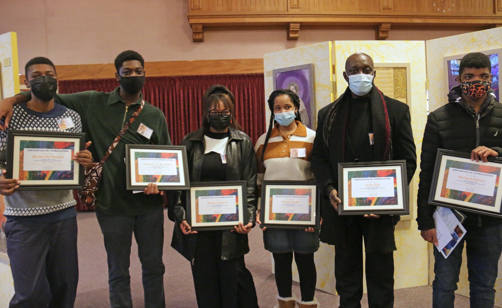 Left to right, Archie McPherson, Habacuc Samuel Bessiake, Nicole Robison, Nevaeh Nesbitt, Joye Ofei and Richard Patton display certificates they received from the Archdiocese of Detroit's Office of Cultural Ministries for their work in the "Celebrate Black Catholics and their Artists" event at St. Suzanne/Our Lady Gate of Heaven Parish.