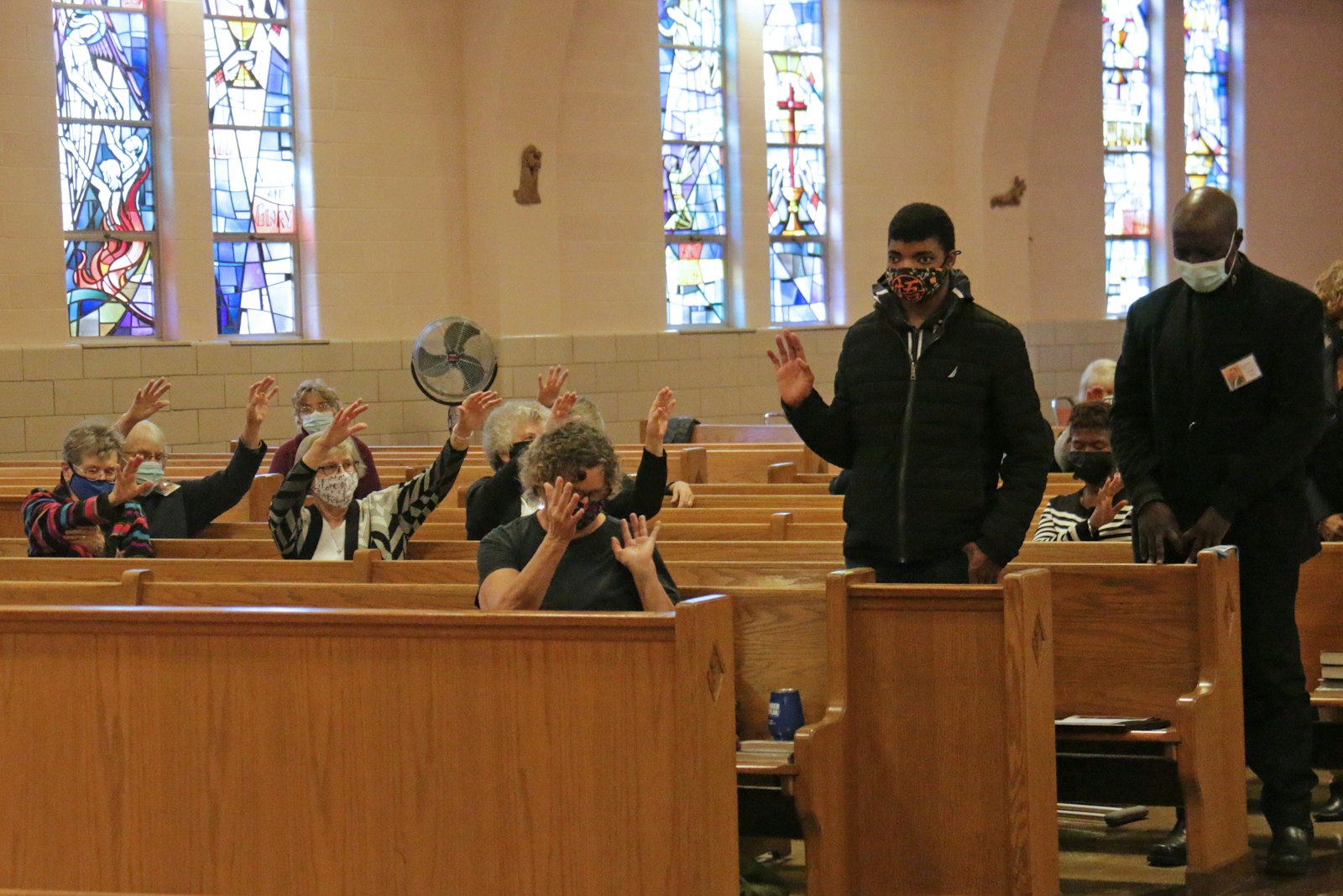 Members of the St. Suzanne/Our Lady Gate of Heaven Parish community extend their hands in charismatic prayer over the artists who took part in the "Celebrate Black Catholics and their Artists" series.