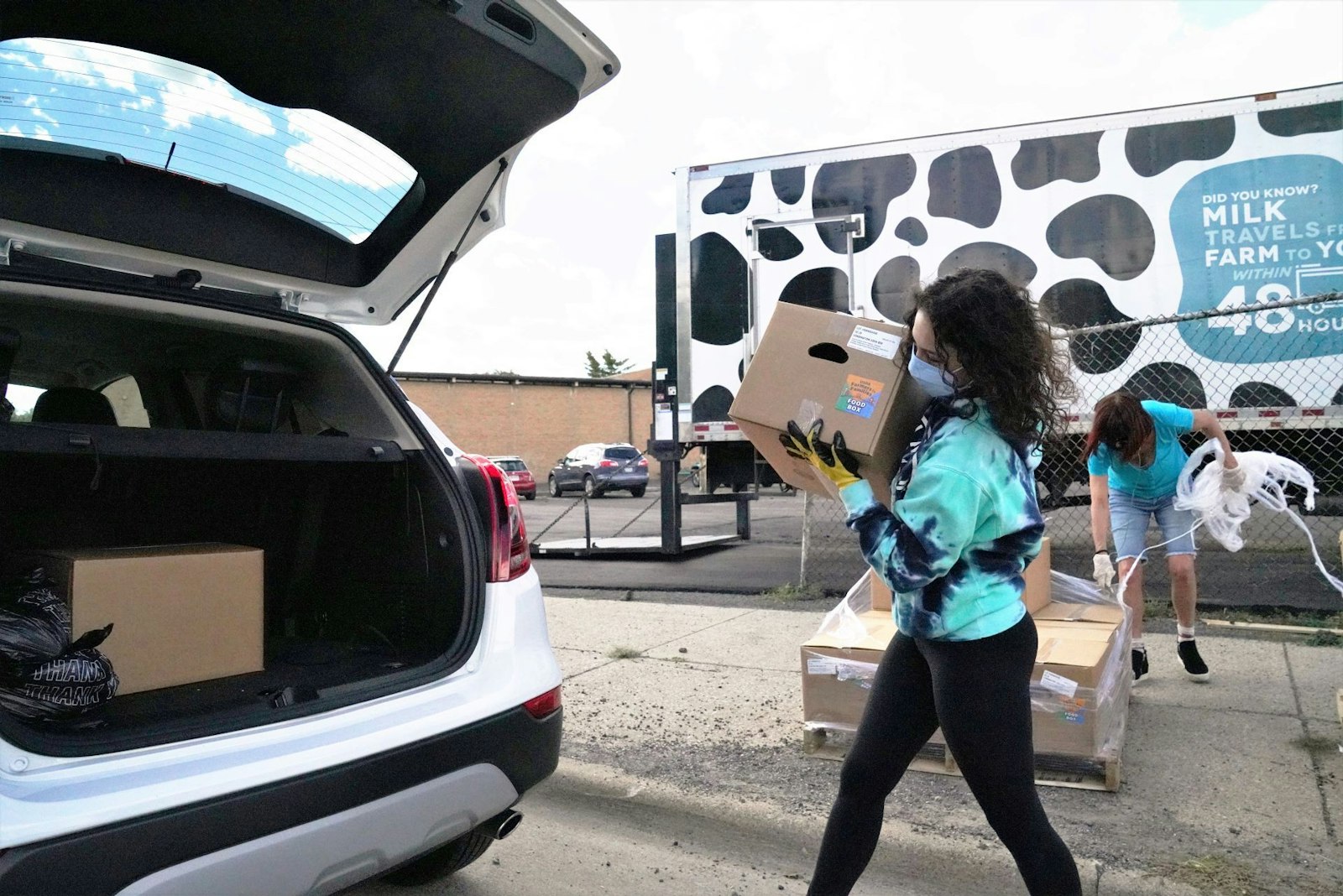 A Gleaners volunteer loads boxes of food into a vehicle during a distribution event in River Rouge. Across the board, Gleaners has seen increases of 10% to 25% for basic grocery items, including dairy, produce and meat. (Courtesy of Gleaners Community Food Bank)