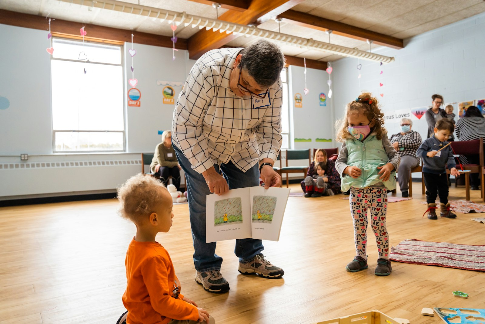 Mary Prevost reads to children during St. Lucy's "Story Time with Moms and Tots" event Feb. 8. The story is followed by a related crafts project, which helps children understand the story's meaning.