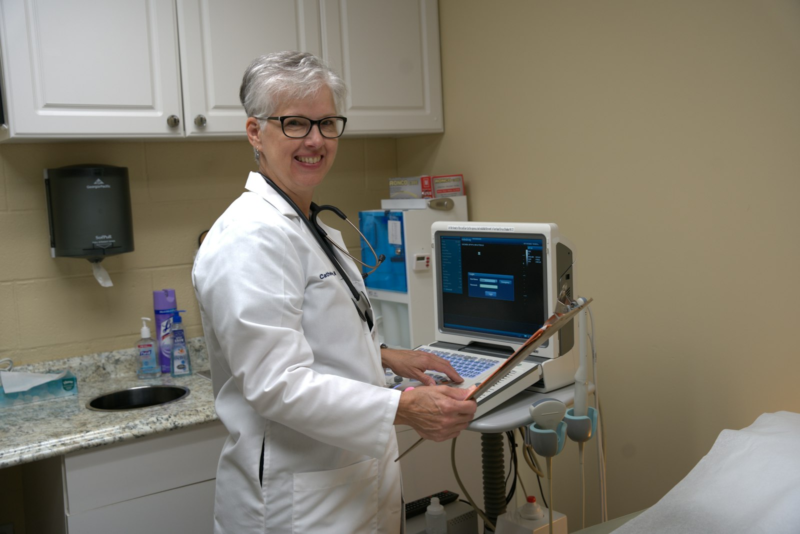 Dr. Catherine Stark, OB-GYN, stands in front of an ultrasound machine at Crossroads Care Center in Auburn Hills. Advances in neonatal medicine, as well as better imaging technology with ultrasounds and sonograms, have brought the humanity of the unborn child into clear focus since Roe v. Wade was decided in 1973, Dr. Stark says. (Daniel Meloy | Detroit Catholic)
