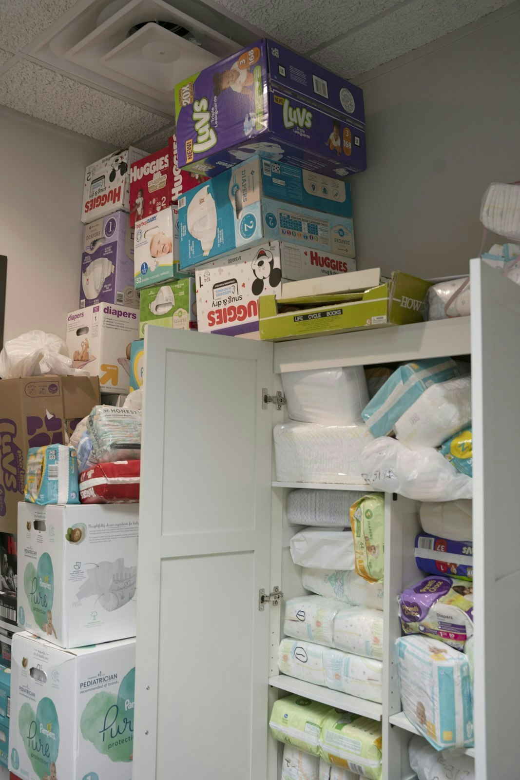 A stack of diapers available for expecting or parenting mothers in need is pictured at Planned Choices pregnancy center in Allen Park in 2022. (Gabriella Patti | Detroit Catholic)