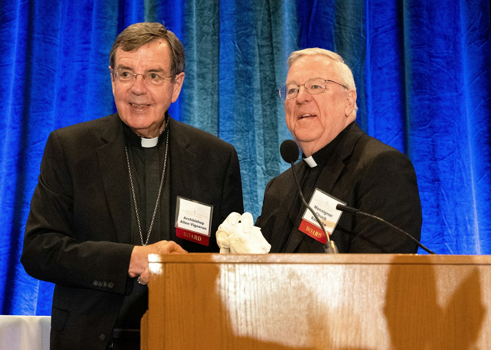 Msgr. Charles Kosanke, right, chairman of the board of Catholic Charities of Southeast Michigan, presents the Leonard R. Jagels Award to Archbishop Allen H. Vigneron. The award honors the memory of Catholic Social Services' former director and is given each year to an individual whose support of Catholic Charities' mission has been indispensable.