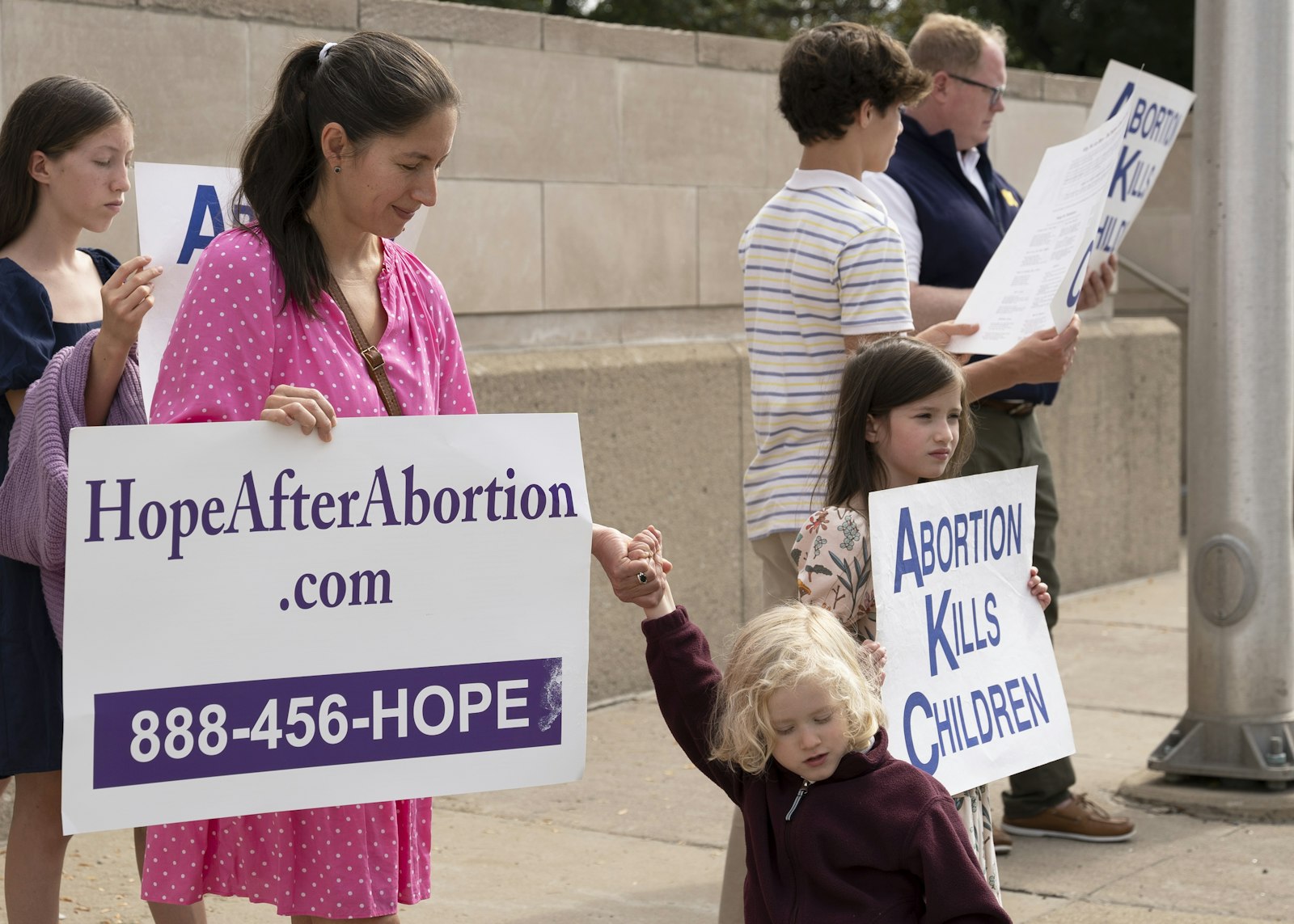 Massgoers hold pro-life signs on Woodward Avenue outside the Cathedral of the Most Blessed Sacrament during a Life Chain on Oct. 1.