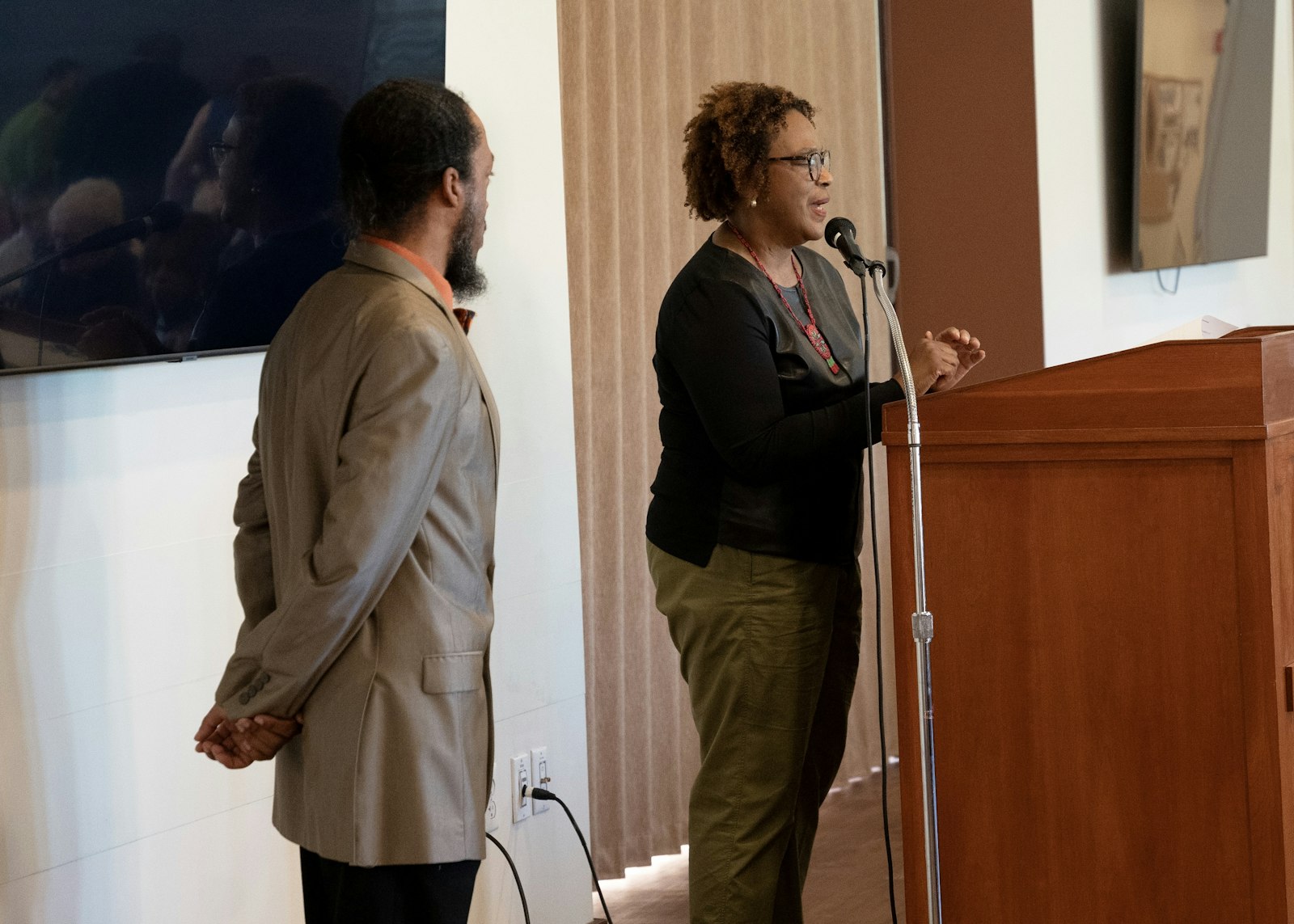 Vickie Figueroa, director of cultural ministries and coordinator of Black Catholic ministry for the Archdiocese of Detroit, speaks alongside the event's master of ceremonies, Alexander Taylor.